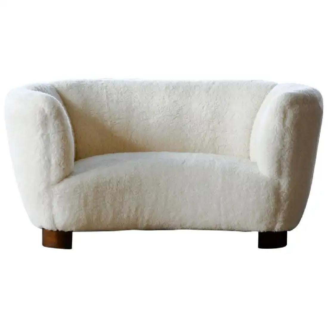Banana shaped Viggo Boesen style curved two-seat sofa or loveseat made in Denmark in the 1940s. This sofa will make a strong statement in any room. Beautiful round lines and iconic ball feet normally associated with Viggo Boesen. Fully refurbished