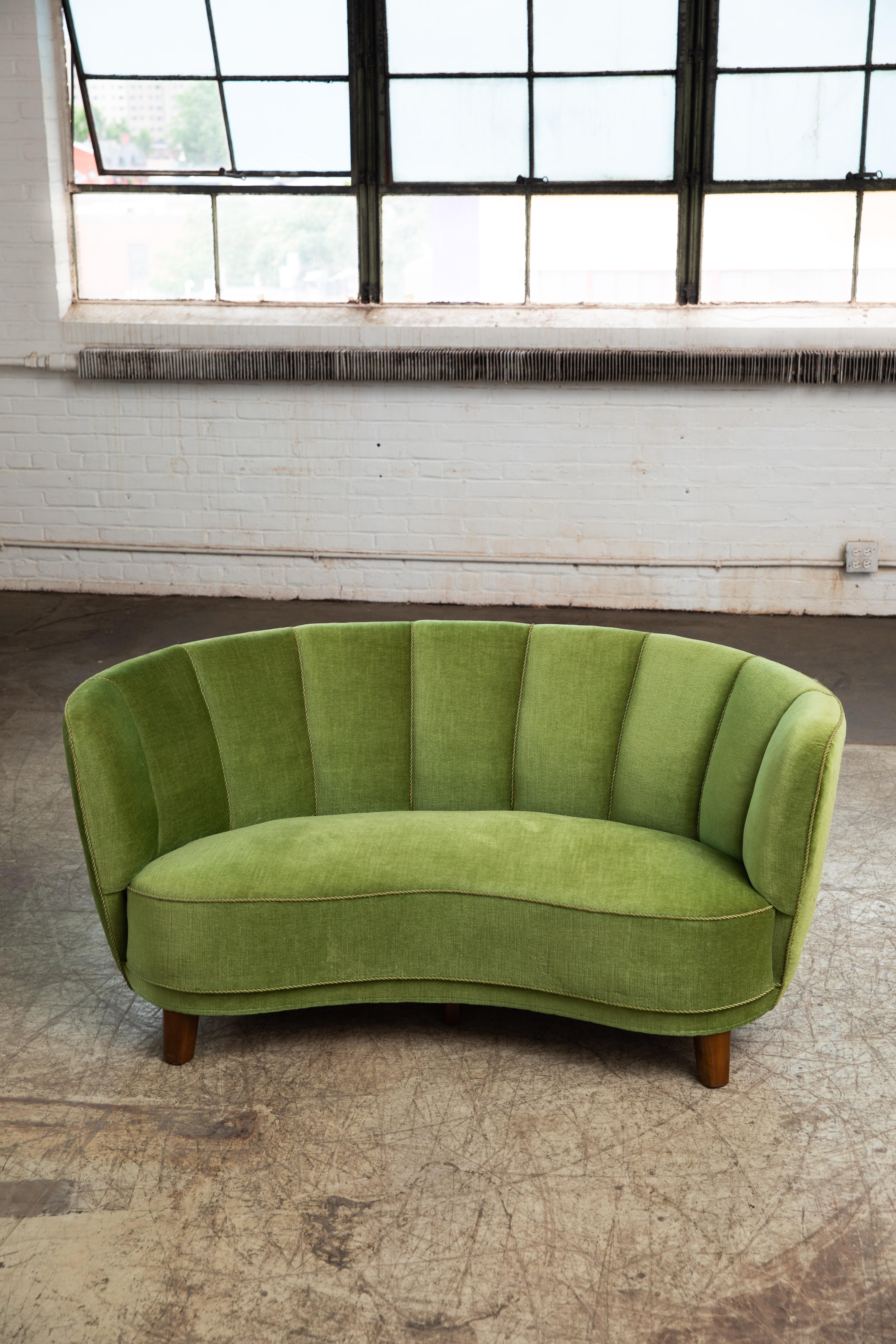 Beautiful and very elegant 1940s curved two-seat sofa in green mohair wool fabric. The sofa has springs in the seat and the backrest and the cushions are nice and firm and the sofa very sturdy. The sofa was re-upholstered at a later point and the