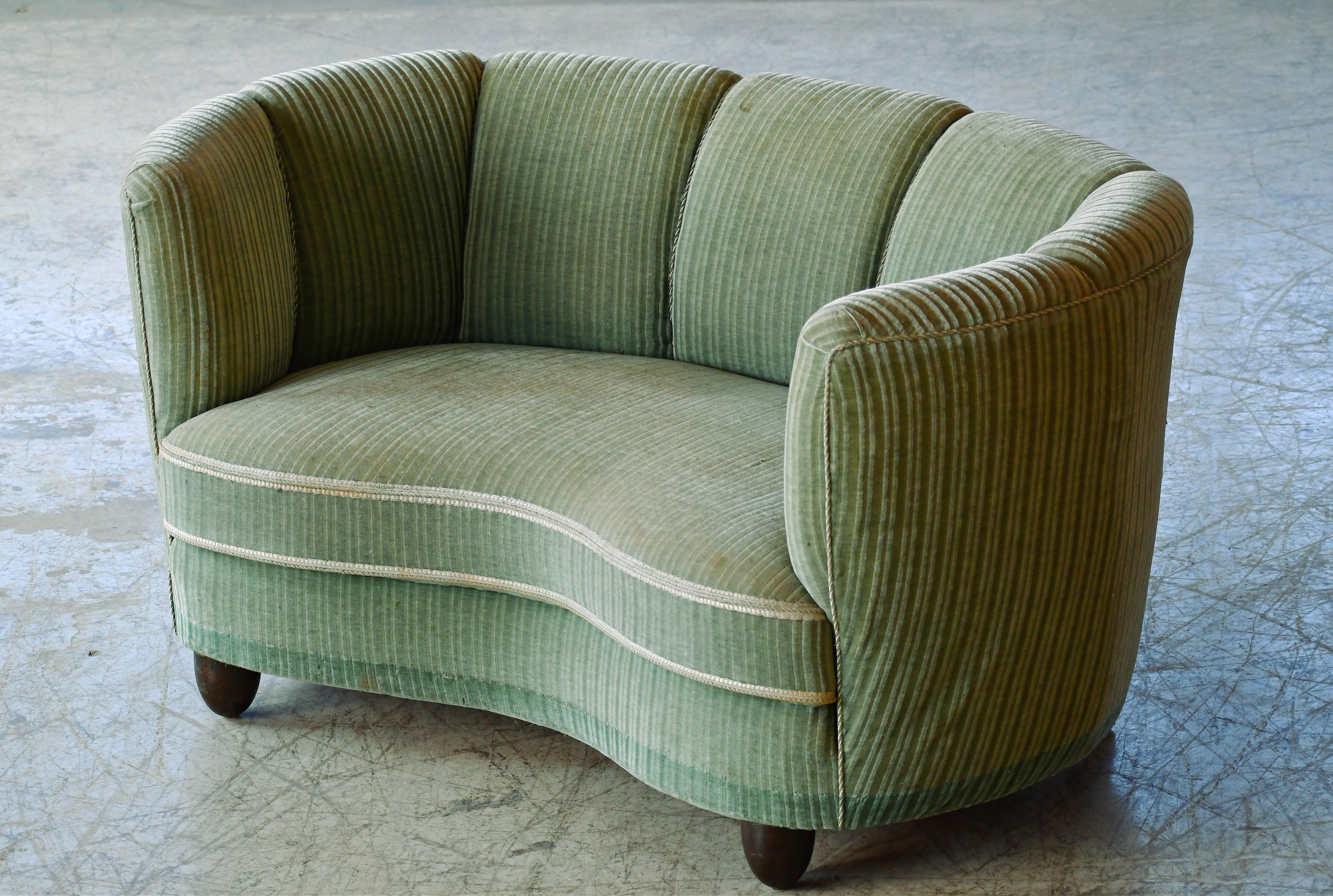 Causeuse en forme de banane ou incurvée, fabriquée au Danemark vers les années 1940. Ce petit canapé fera sensation dans n'importe quelle pièce. De belles lignes rondes et voluptueuses et de solides pieds carrés. Le charmant tissu mohair vert rayé