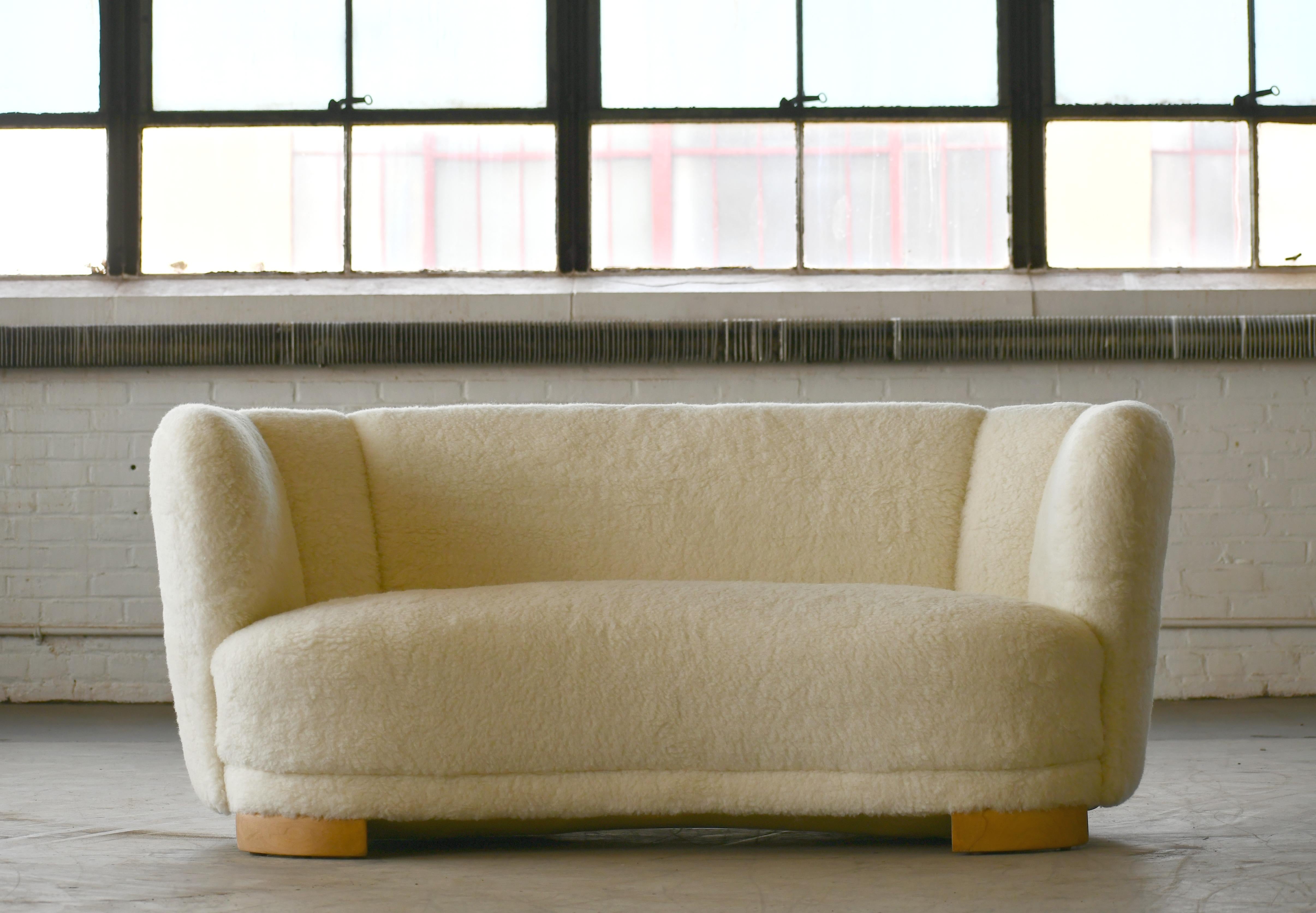 This sofa is currently in transit from Denmark and will be available on or around October 1st, 2020.

Viggo Boesen style banana shaped or curved sofa reupholstered in new lambswool made by Slagelse Møbelværk in the 1940s. This sofa will make