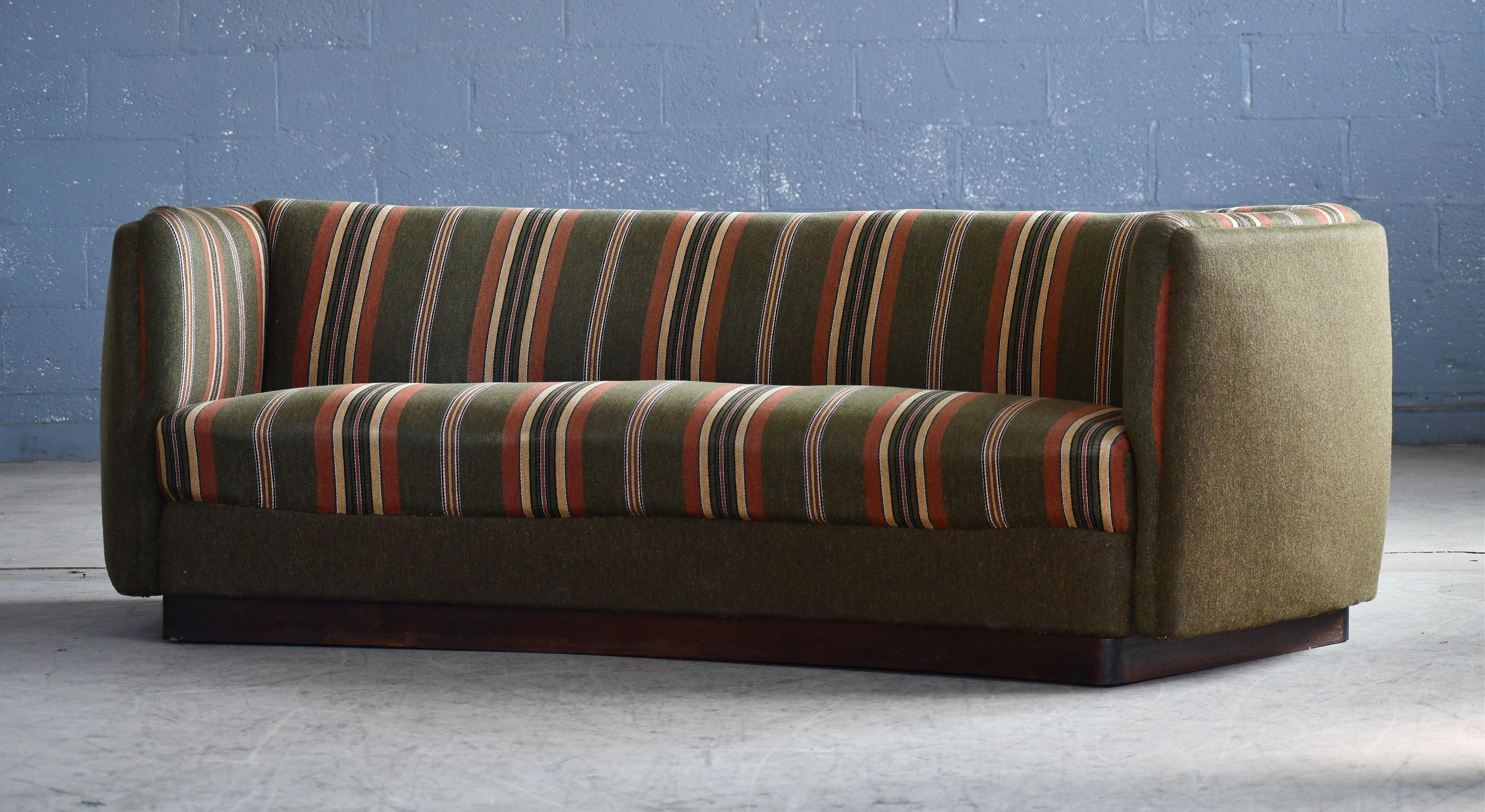 Superb and rare sofa designed by Ole Wanscher and produced by Fritz Hansen as model 1668 probably in the 1940. The model was seen in Fritz Hansen's catalog #4202 in 1951 and earlier variants were around in the late 1930's and up through the 40's.