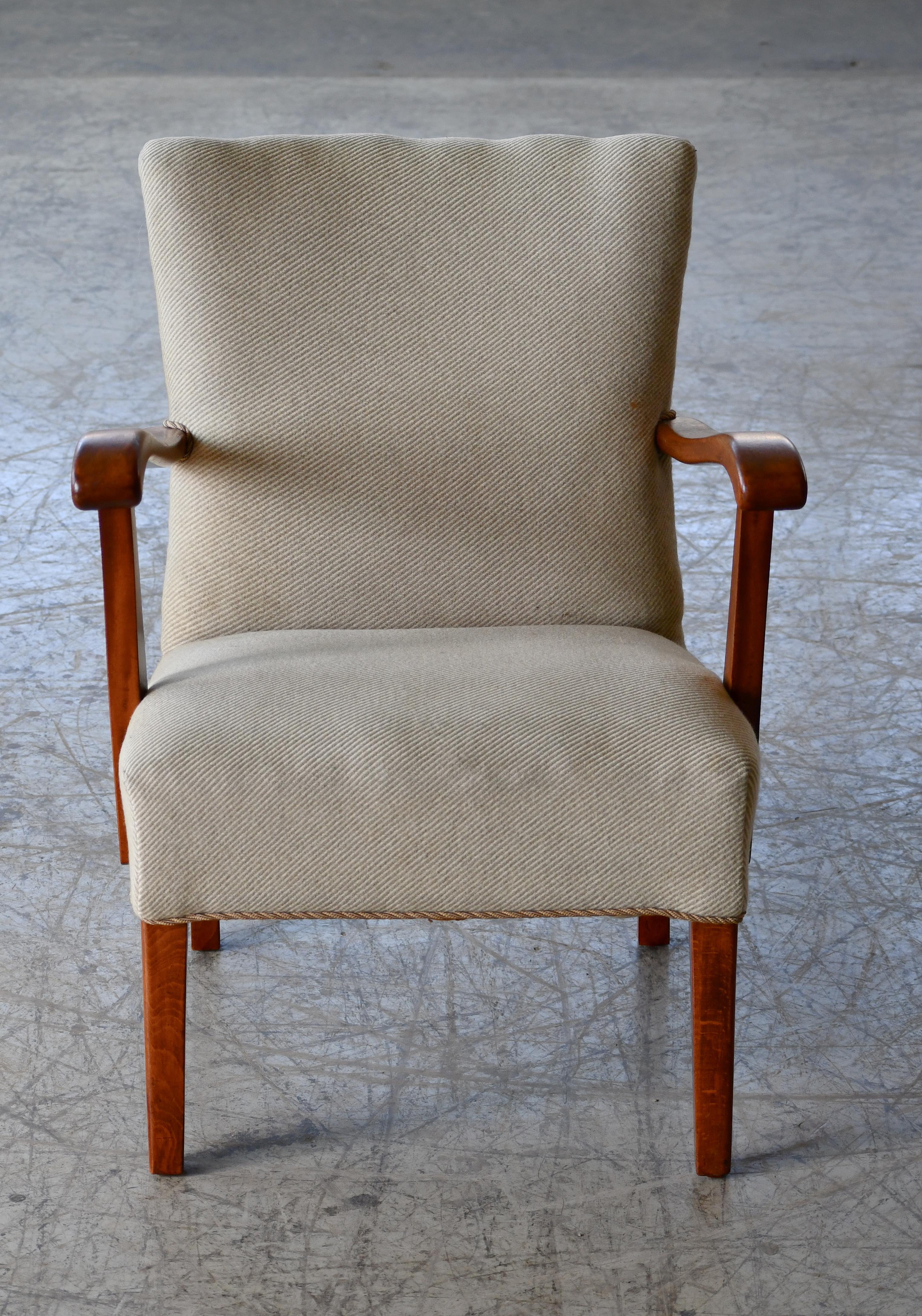 Very cool and elegant Danish easy chair most likely made late 1940's. Unknown Designer/Maker but classic Danish modern design. Armrests and frame made from solid beech. Coild spings in the seat. Not large but with strong presence making the chair