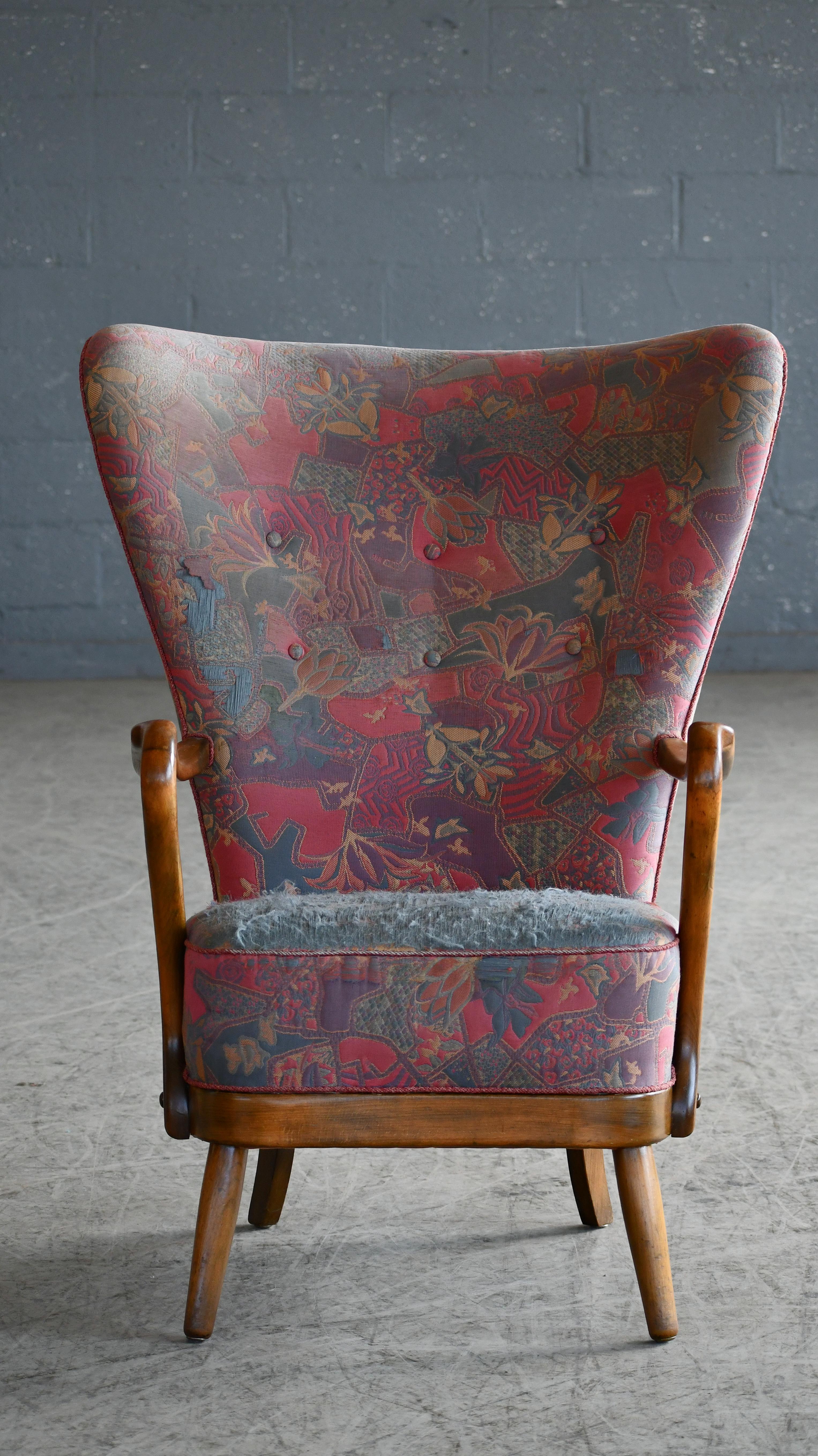 Classic elegant Danish high back armchair from the 1940s by Alfred Christensen for Slagelse Mobelvaerk with open armrests in beautifully carved Cuban Mahogany. It's rare to find one of these chairs in mahogany as the advent of second world war