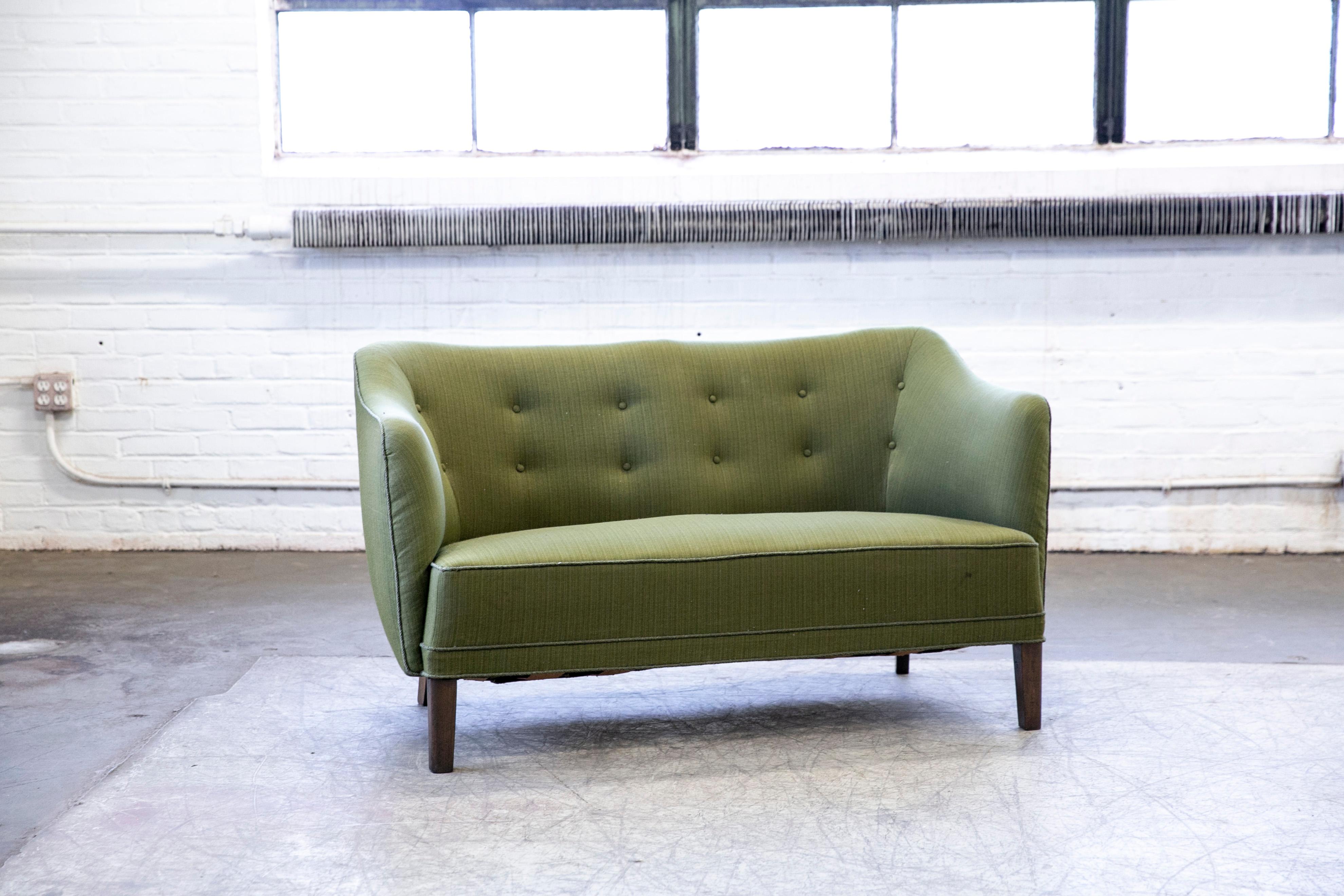 Superbly elegant Finn Juhl style sofa or settee attributed to Slagelse Mobelvaerk, Denmark made sometime in the 1940s. Perfectly balanced lines and proportions providing for a solid and sturdy yet very elegant design. The sofa was re-upholstered in