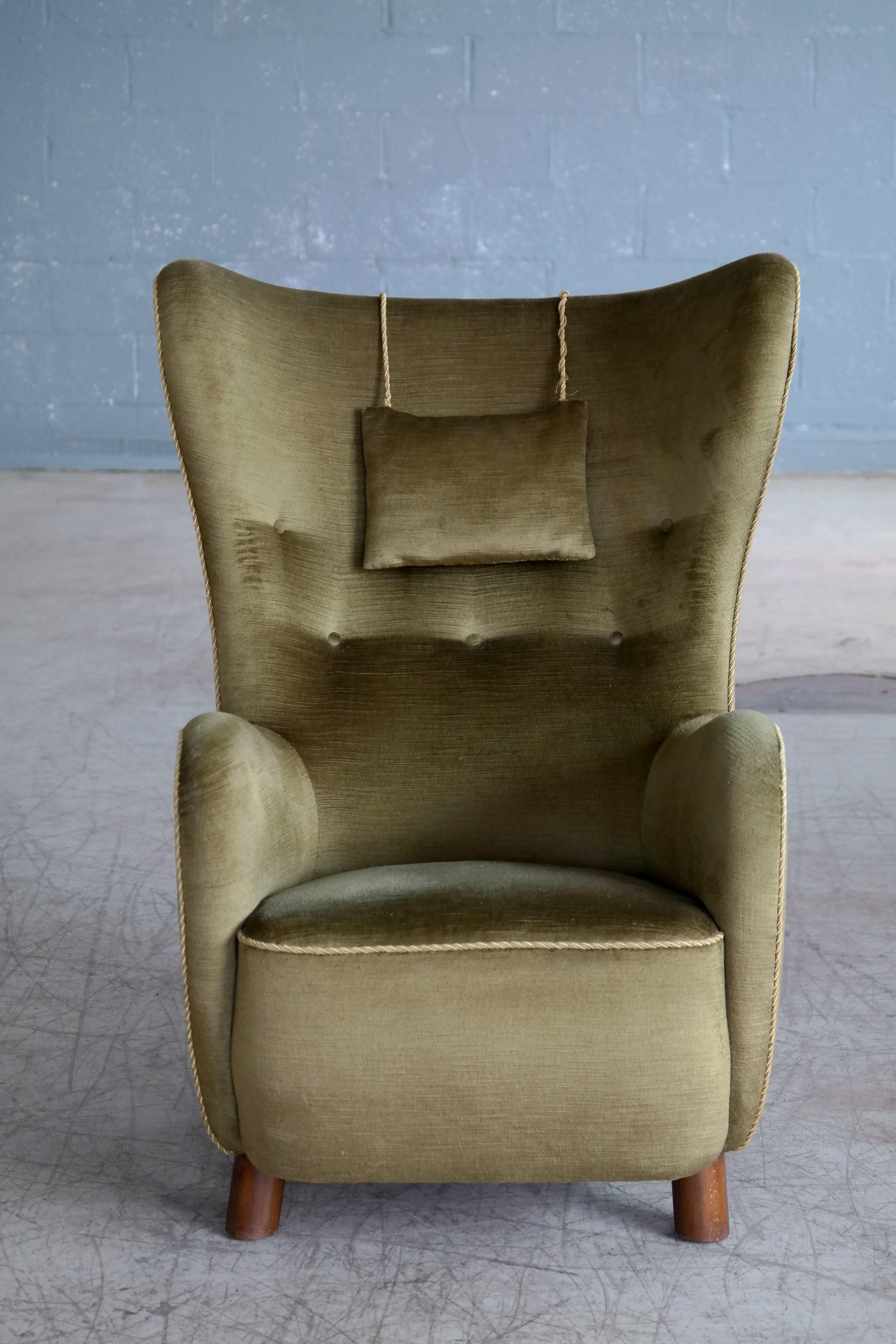 Beautiful Flemming Lassen attributed high back lounge chair made circa 1940. This iconic lounge chair is probably one of the most perfect high backs ever designed. Perfect statement piece with its ultra-elegant sensual shape yet very comfortable and