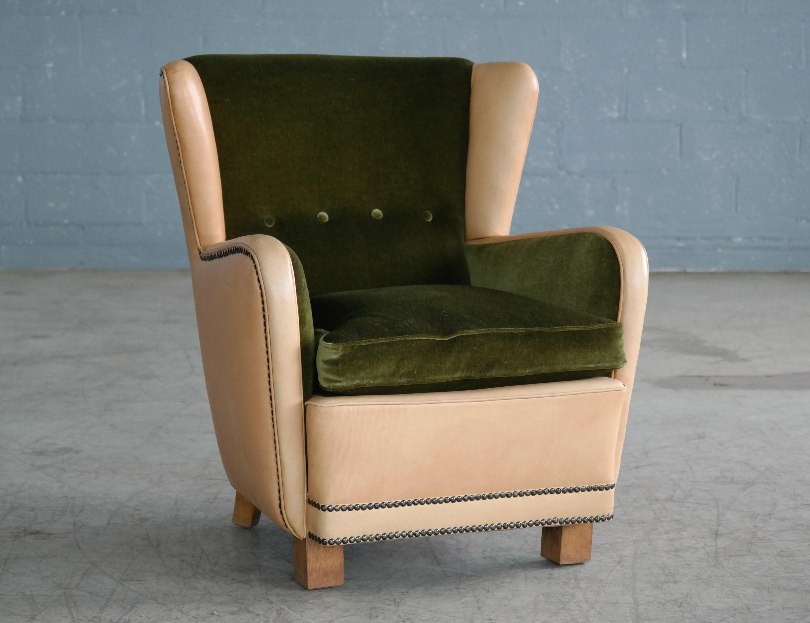 Superb and unique Classic Danish 1940s club chair in the style of Fritz Hansen. The chair has a nice stance and strong presence and is solid and sturdy while being superbly comfortable. The chair has been expertly re-upholstered at a later point in