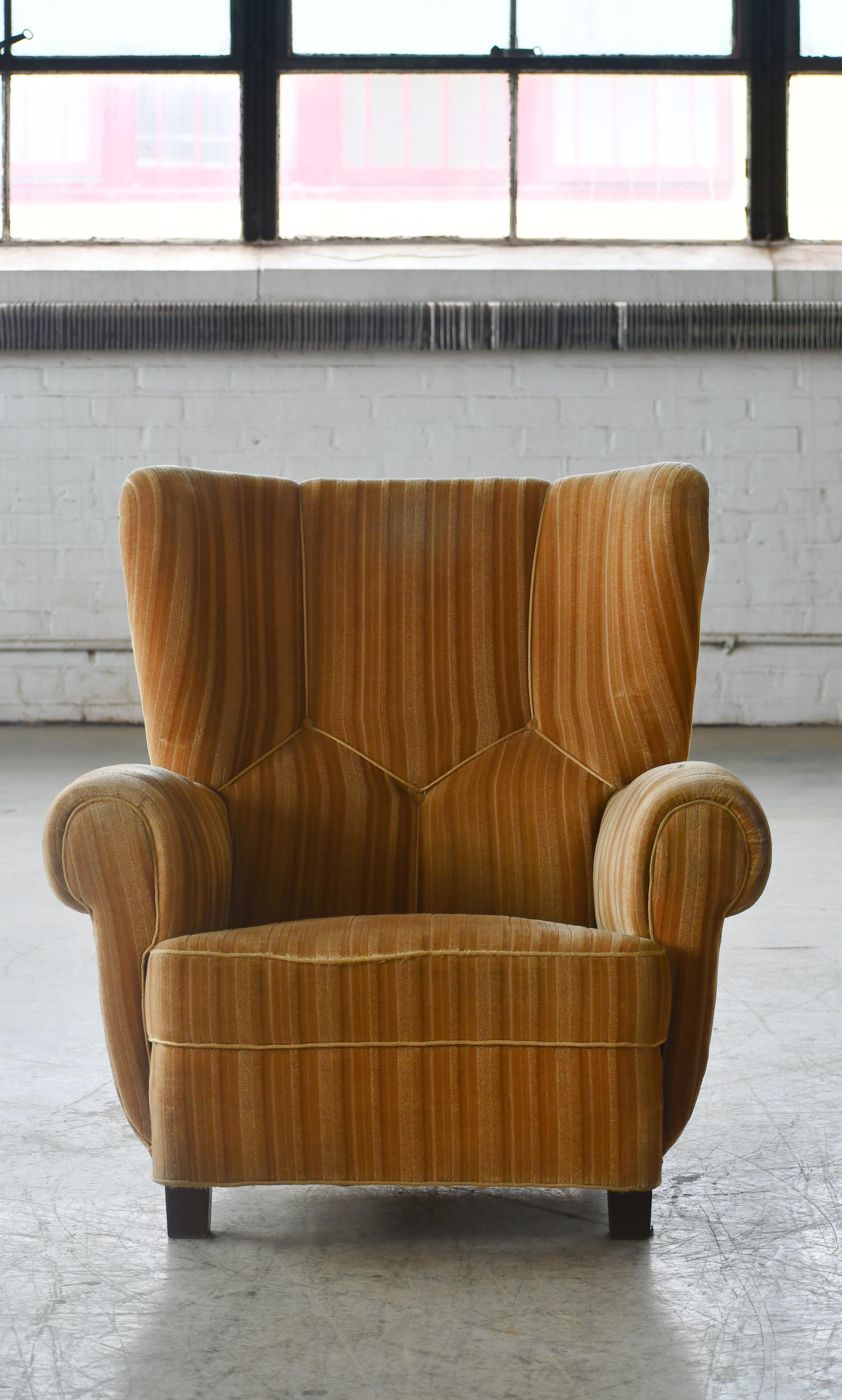 Classic Danish large-scale club or lounge chair similar to Fritz Hansen's styles from the same period from 1930-early 1940s. This chair has higher backrest and a straighter front which provides for a very cool look. Super comfortable with coil