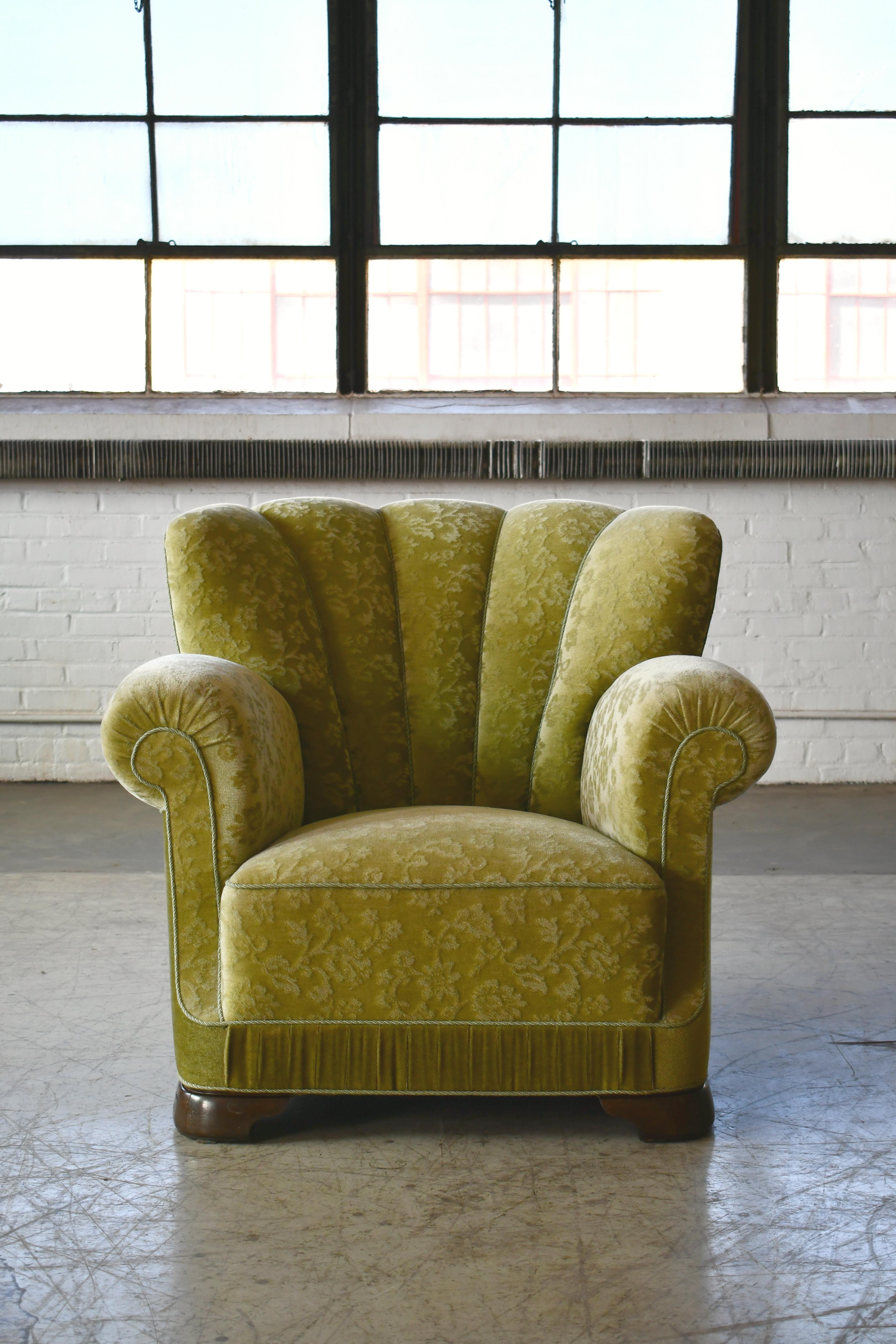 Sublime large scale Danish club or lounge chair made in the late 1930s. The chair is almost identical to Fritz Hansen's model 1518, however, this chair has Art Deco style legs where Fritz Hansen's model 1518 has square legs. But it is not unlikely