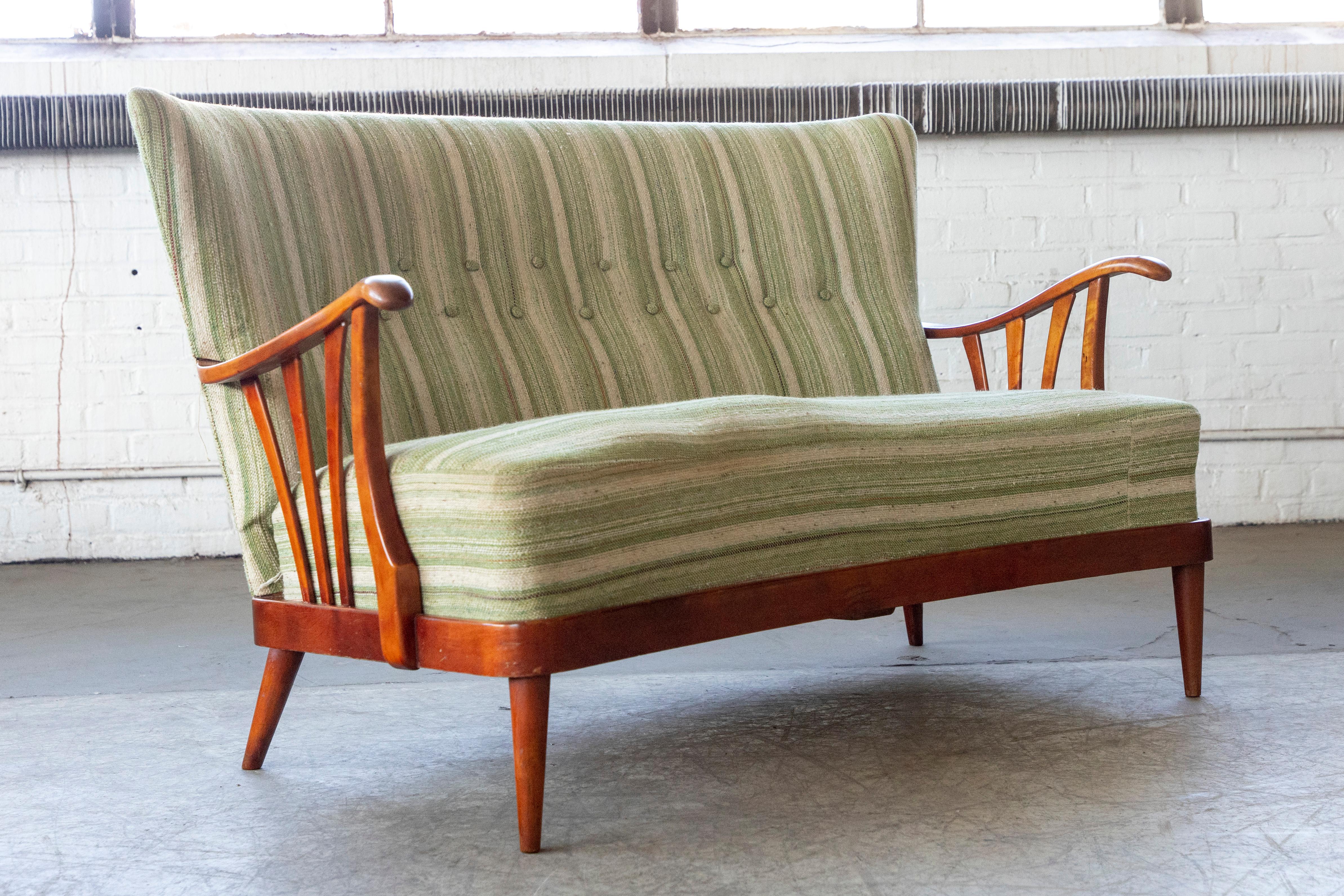 Very charming loveseat from the 1940's in the style of Alfred Christensen. Maker and Designer is unknown but the style is very similar to designs by Fritz Hansen and Alfred Christensen at the time. Spring loaded cushion and backrest. Reupholstered