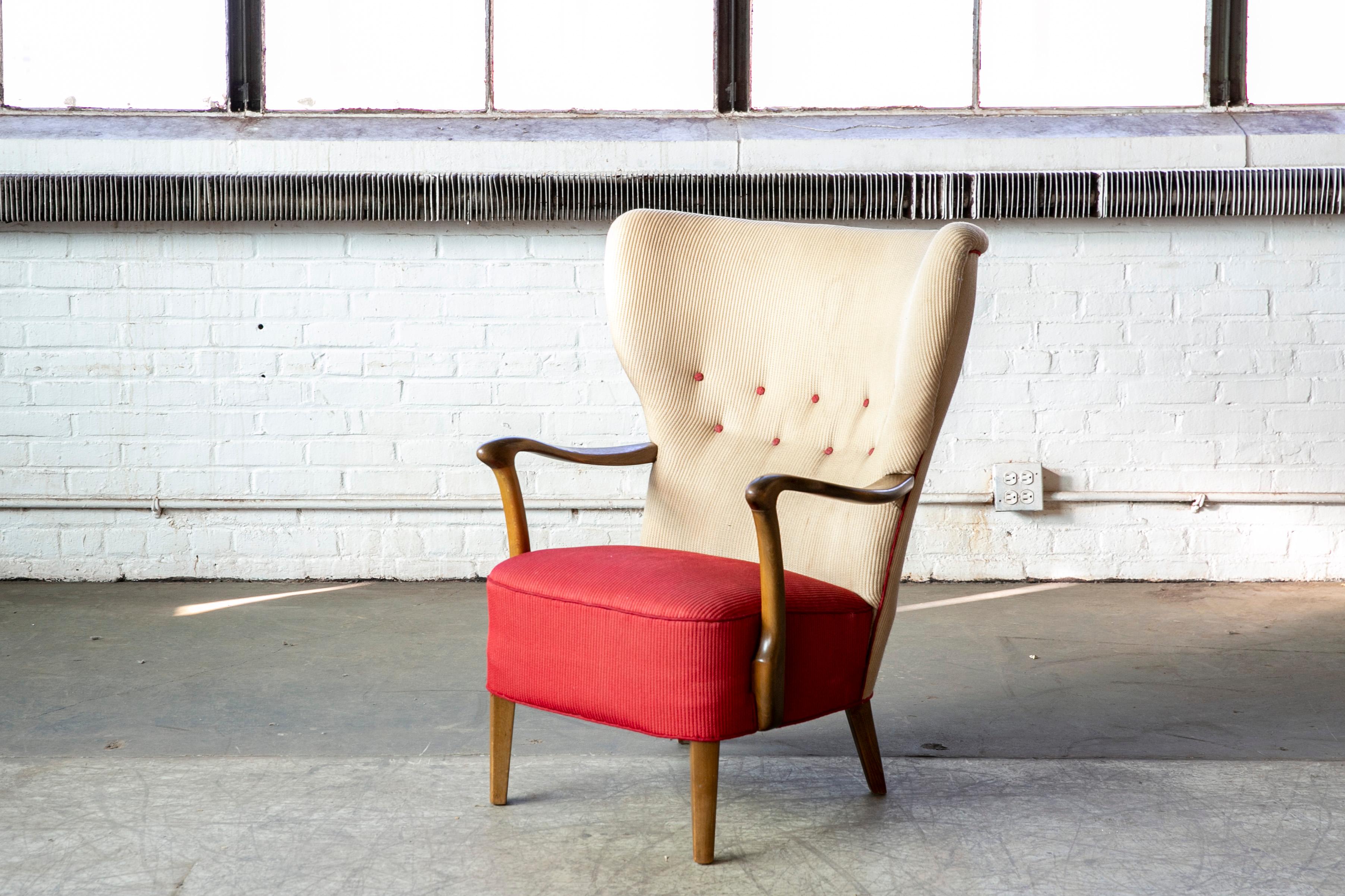 Classic Danish high back armchair from the 1940s in the style of Fritz Hansen and Alfred Christensen with open armrests in beautifully curved stained beech. Very comfortable nice slim elegant silhouette. Solid and sturdy construction. The fabric and