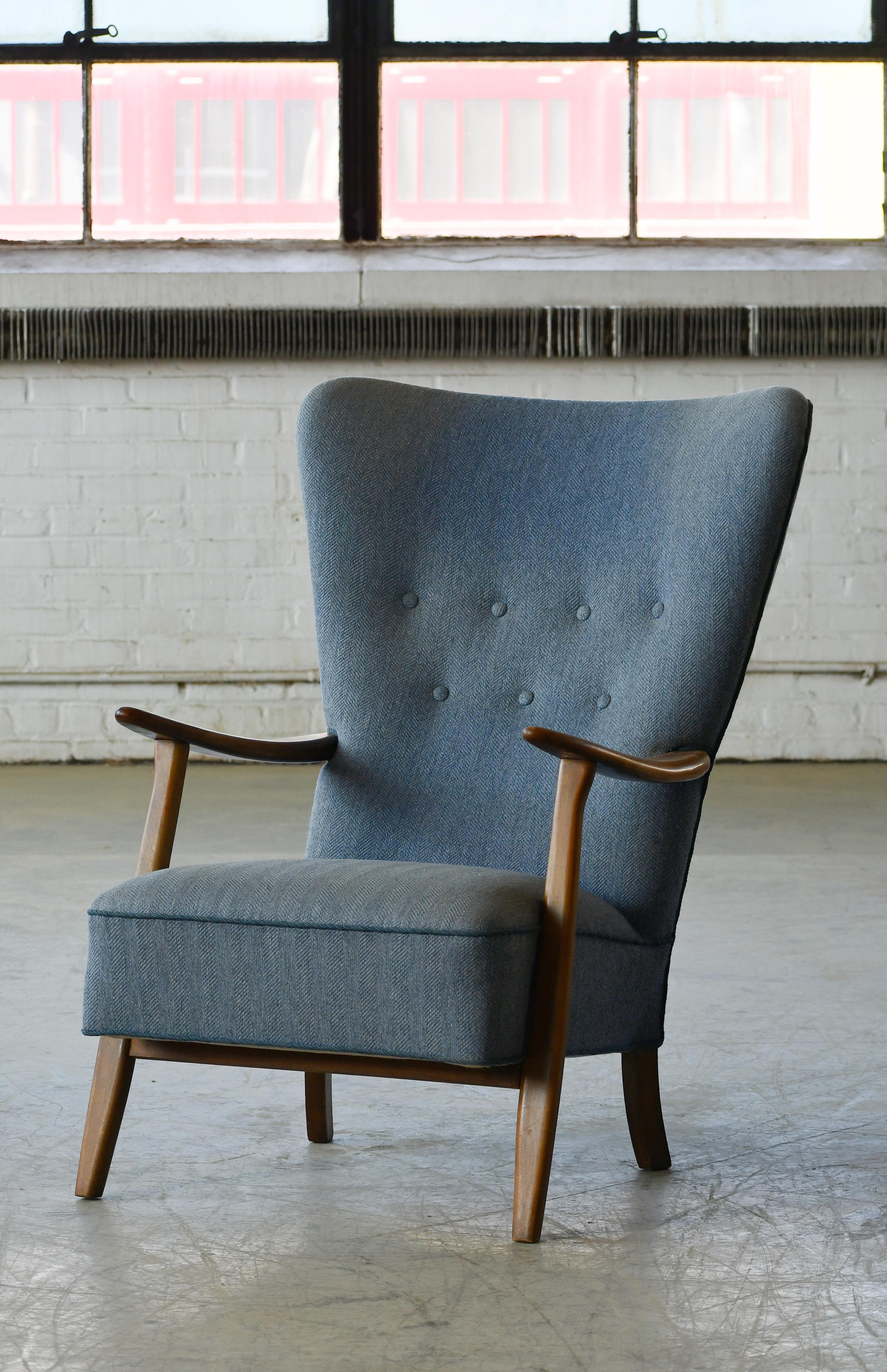 Classic Danish very comfortable high back armchair from the 1940s in the style of Fritz Hansen and Alfred Christensen with open armrests in beautiful stained beech. Nice slim elegant silhouette. Solid and sturdy construction. The fabric and padding