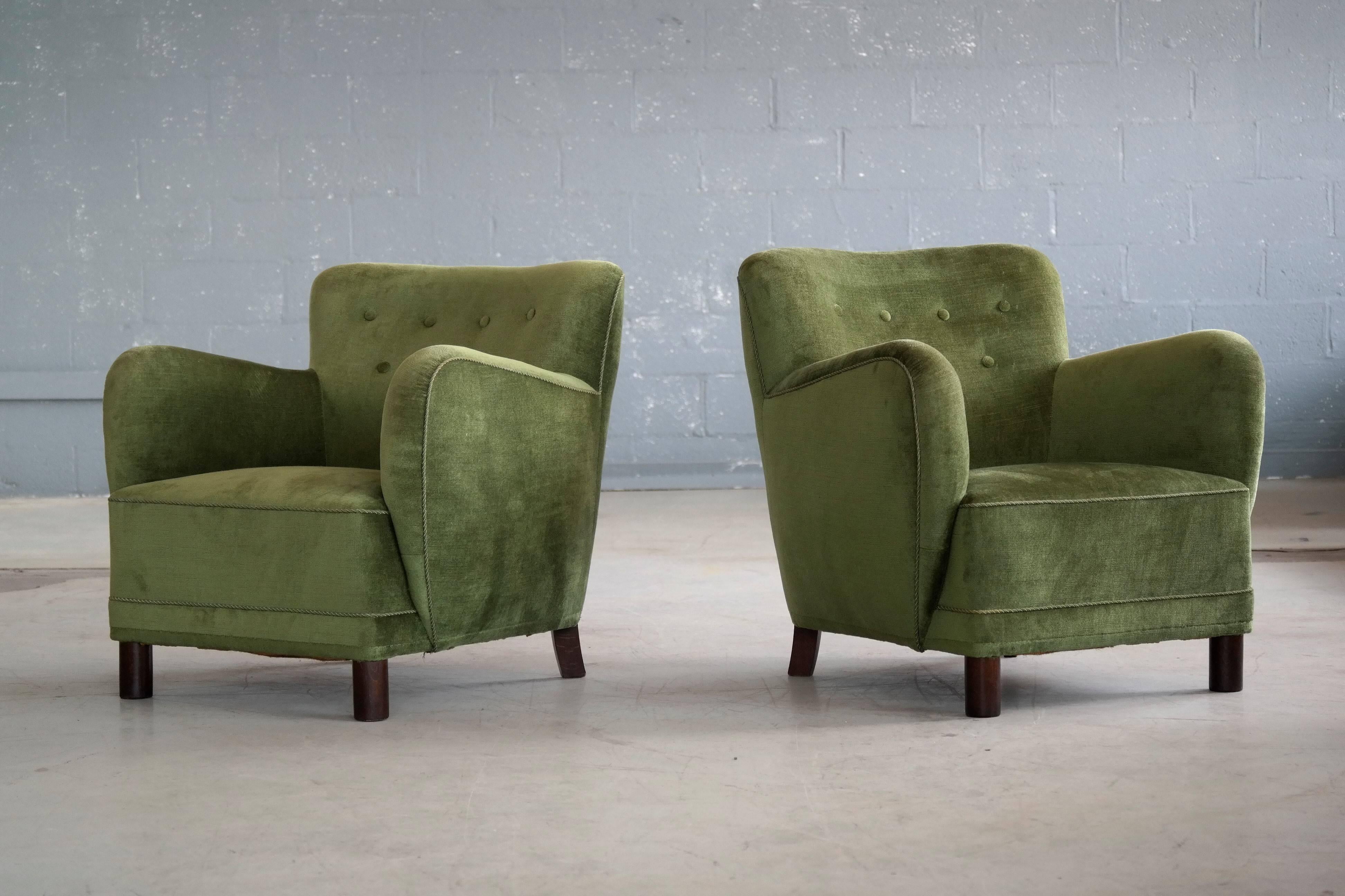 Rare to find Mogens Lassen attributed pair of low back lounge chairs from the 1940s featuring the rounded armrest design and the cylindrical front legs that are very characteristic of Lassen. Lassen's unique style is increasingly coveted and copied