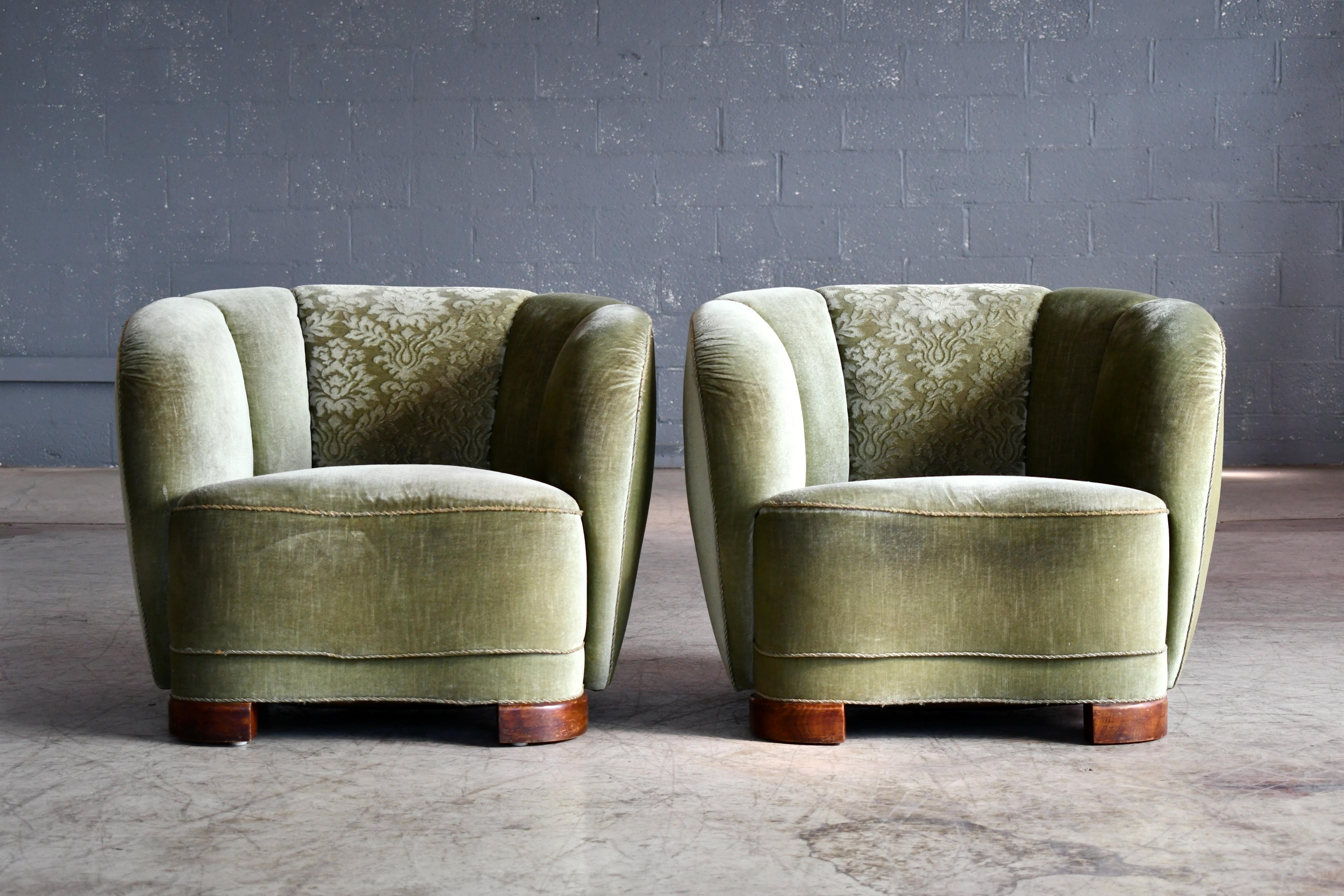 Incredibly comfortable, exuberant, and superbly made pair of Danish lounge chairs perfectly capturing the essence of 1940s Danish design coming out of the Art Deco era and into the midcentury. The curved backrests and low slung proportions and block