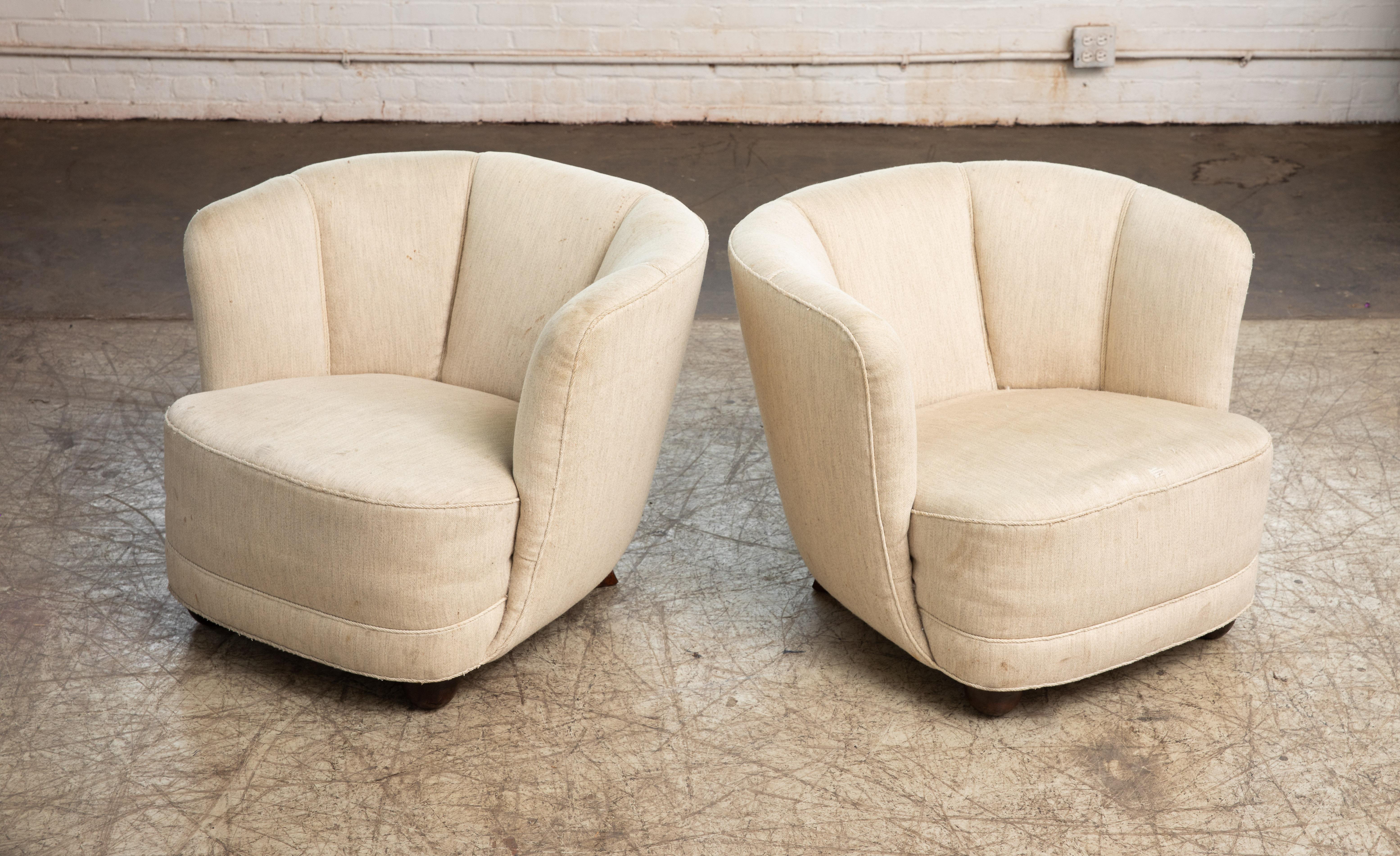 Incredibly comfortable, exuberant, and superbly made pair of Danish lounge chairs perfectly capturing the essence of 1940s Danish design coming out of the Art Deco era and into the midcentury. The curved backrests and low slung proportions and block