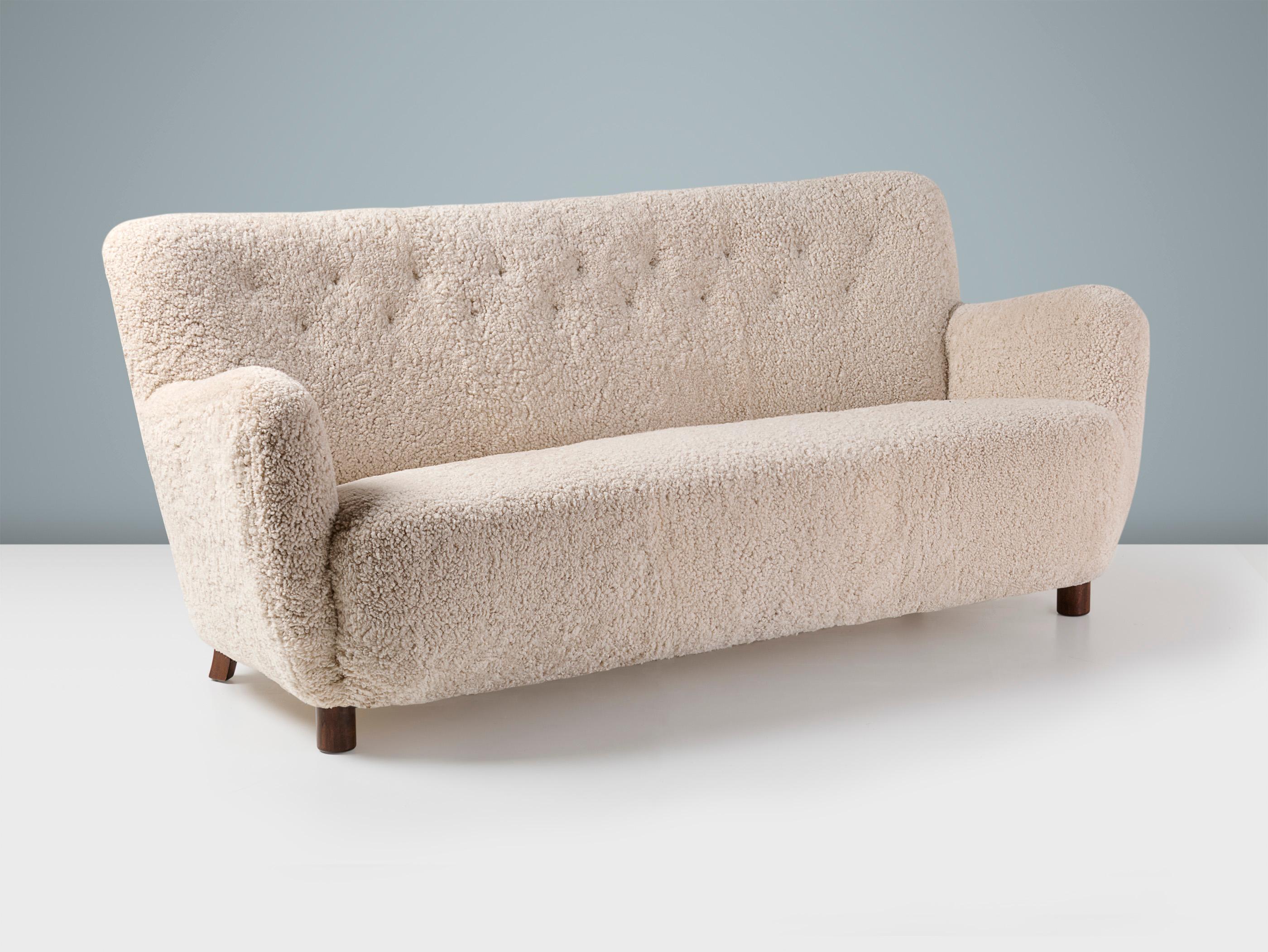 Danish Cabinetmaker - Sofa, c1940s

A wonderful example of post-war Danish sofa design. This cabinetmaker-made piece was produced in Denmark in the late 1940s. This example has been reupholstered in luxurious cream 'Moonlight' sheepskin at our