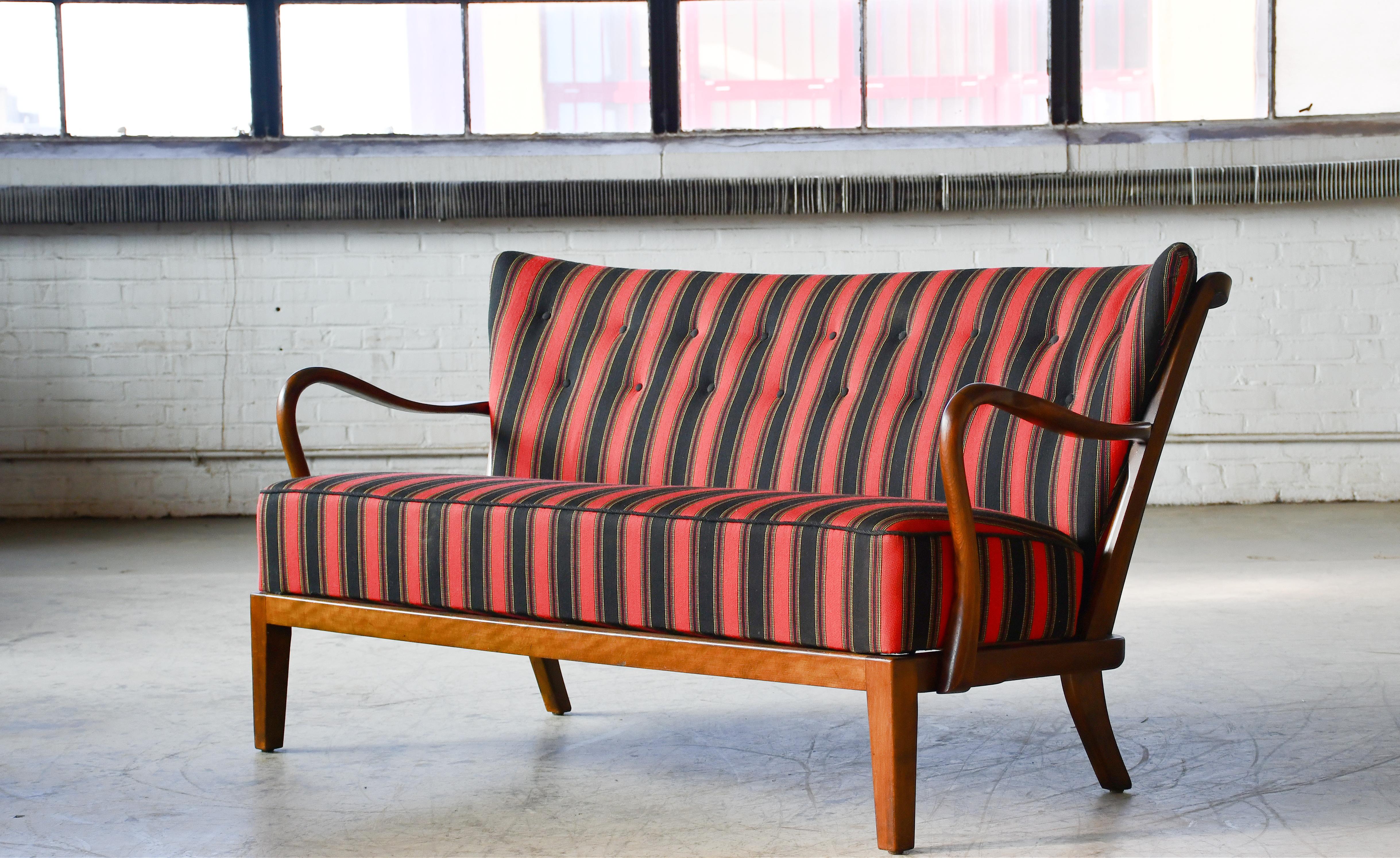 Sculptural and very beautiful 1940s model 117 high back open arm sofa made of stained and lacquered beech wood designed by Alfred Christensen for Slagelse Mobelvaerk. The sofa was seen in Slagelse's catalog no. 4401 from 1944. Beautiful refined