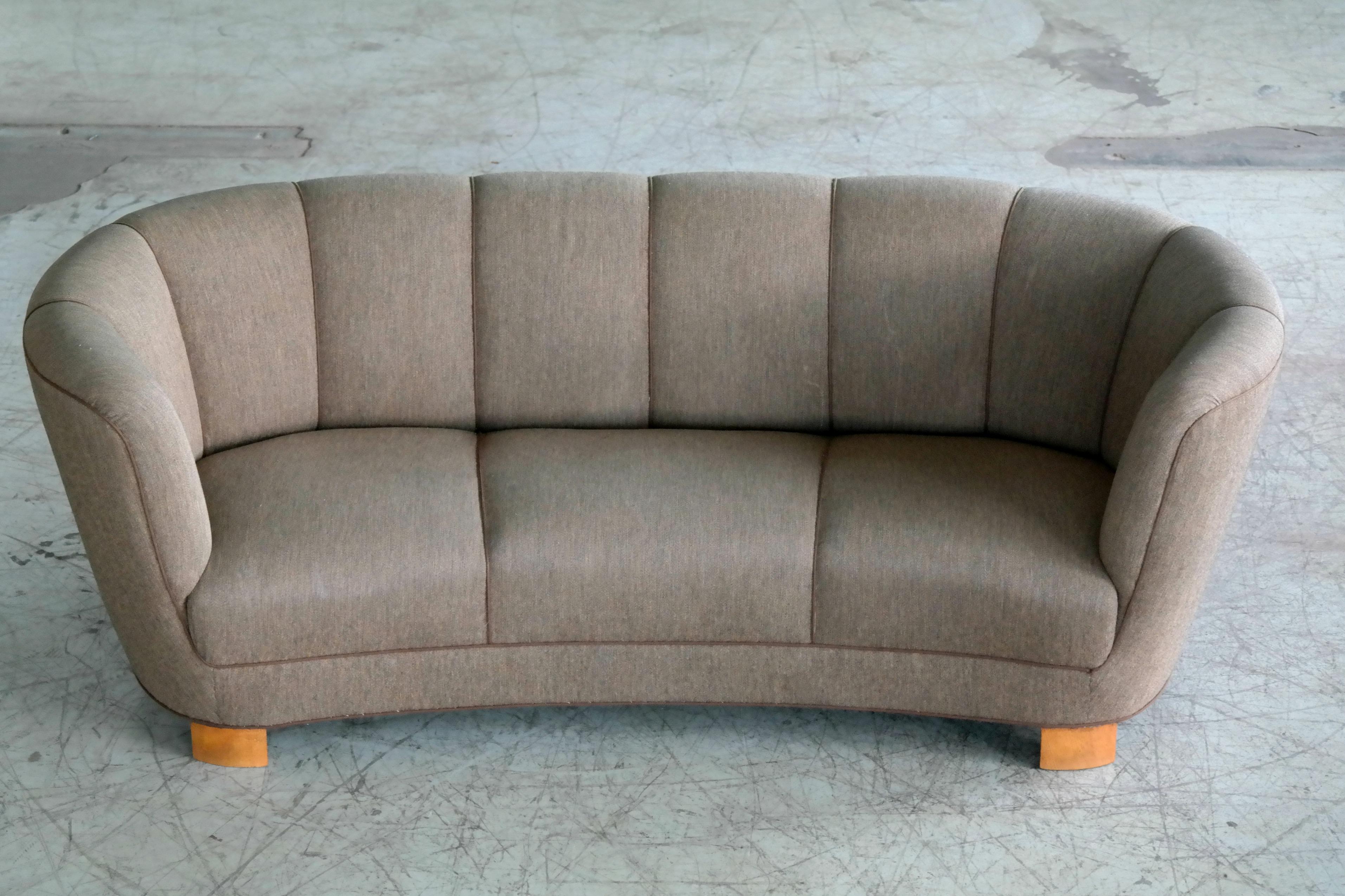 Beautiful and very elegant 1940s curved three-seat sofa in brown wool fabric. The sofa has springs in the seat and the back rest and the cushions are nice and firm and the sofa very sturdy. The wool fabric is in good condition showing just minor