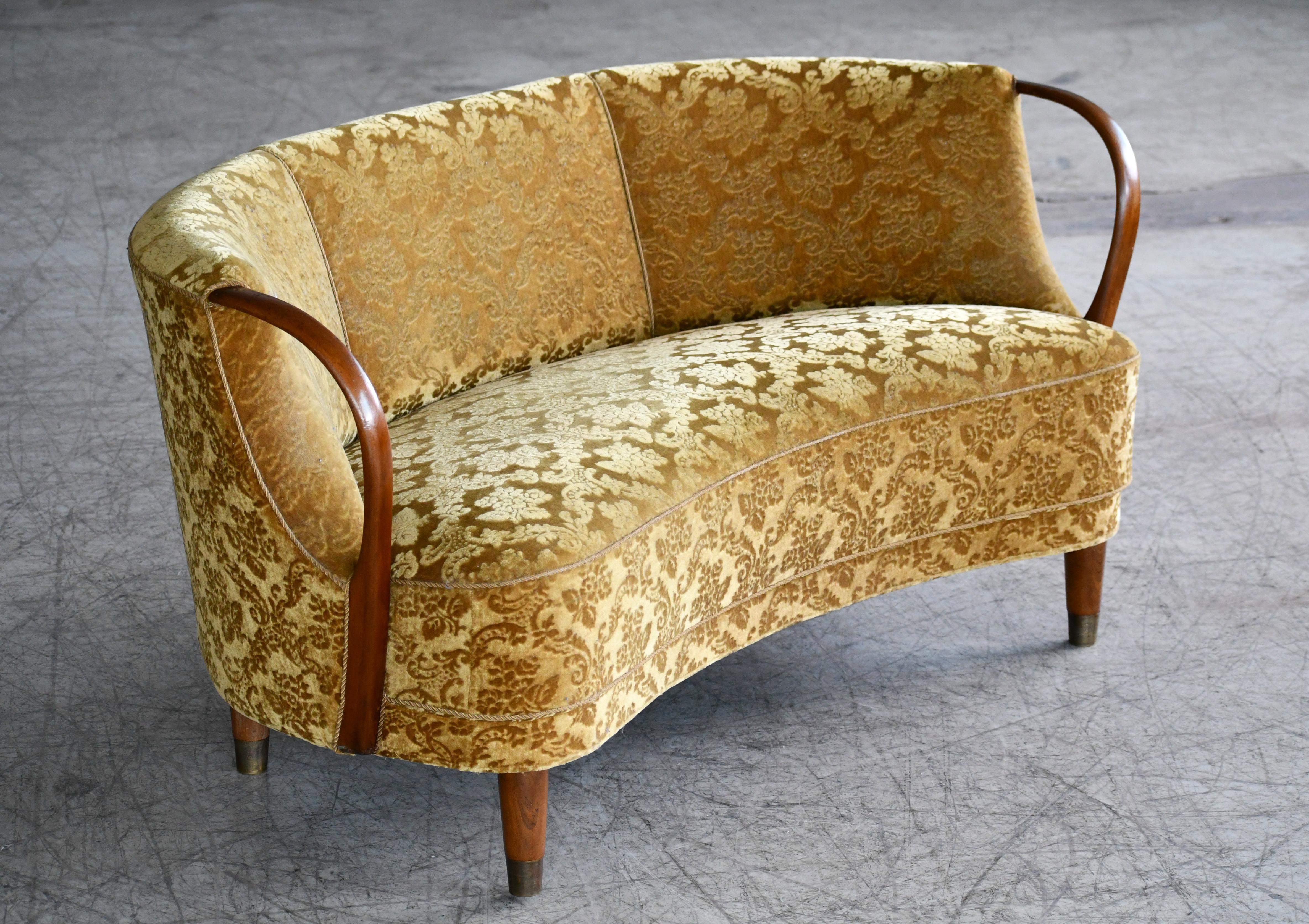 Unique and just superb curved or banana shaped loveseat or settee with open armrests designed and made as Model 96 by N.A. Jørgensens Møbelfabrik in 1954-1955. N.A. Jørgensen is better known under the name Bramin Møbler a name they adopted in the