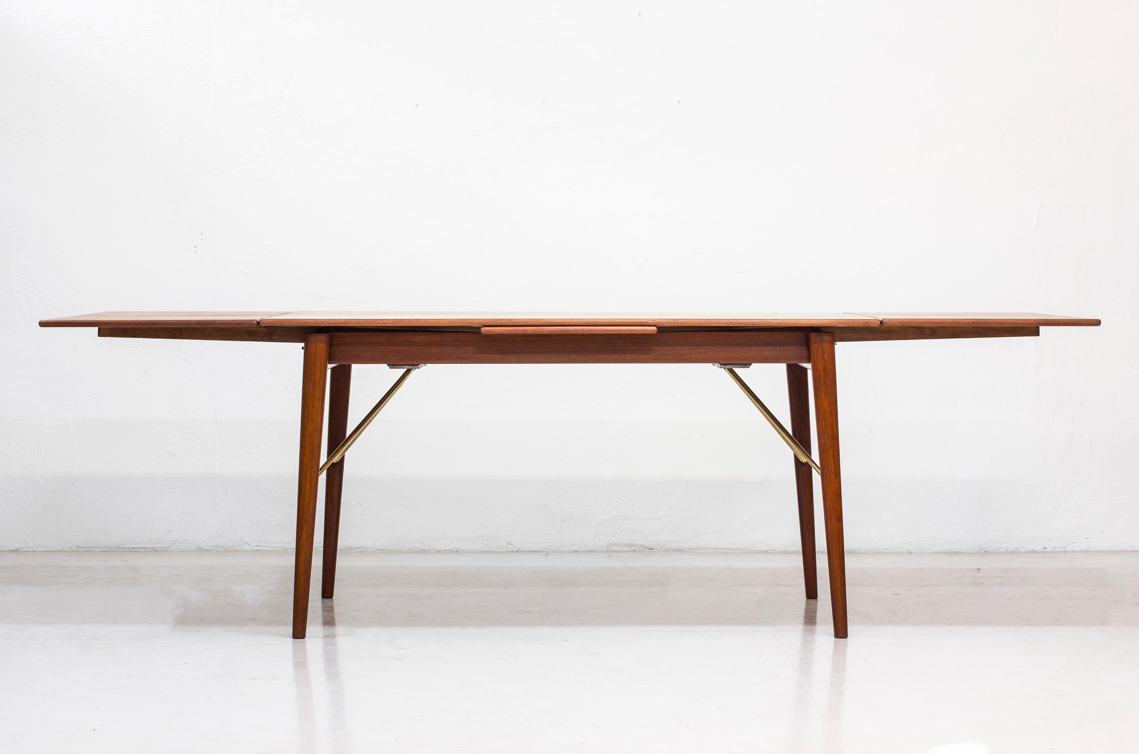 Dining table designed by Peter Hvidt & Orla Mølgaard Nielsen. Produced in Denmark by Søborg Furniture during the 1950s. Made from teak wood with brass details. Dutch style inlays. Good vintage condition with some age related wear and