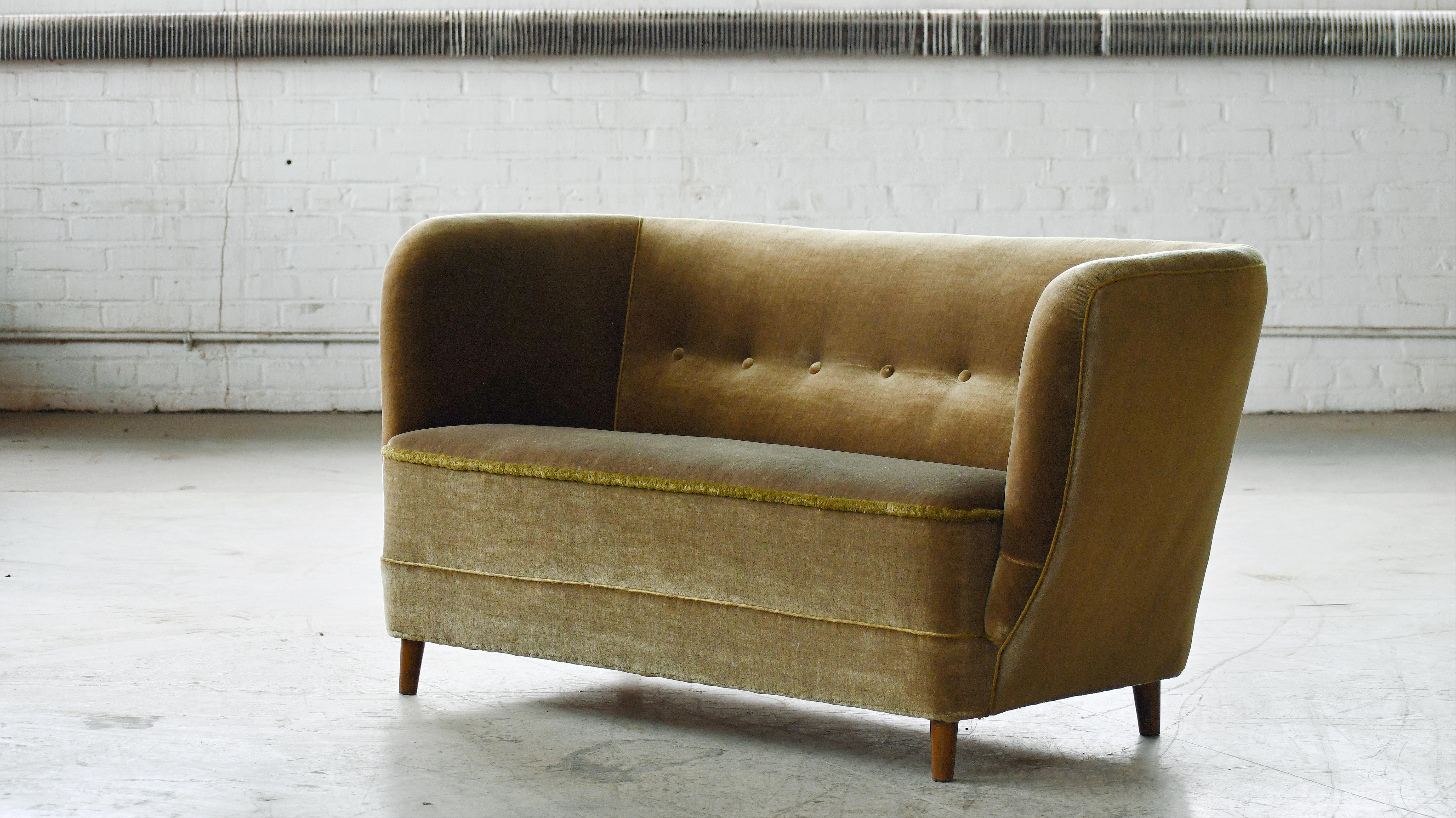 Charming Danish 1950's loveseat. From the era of the curved 