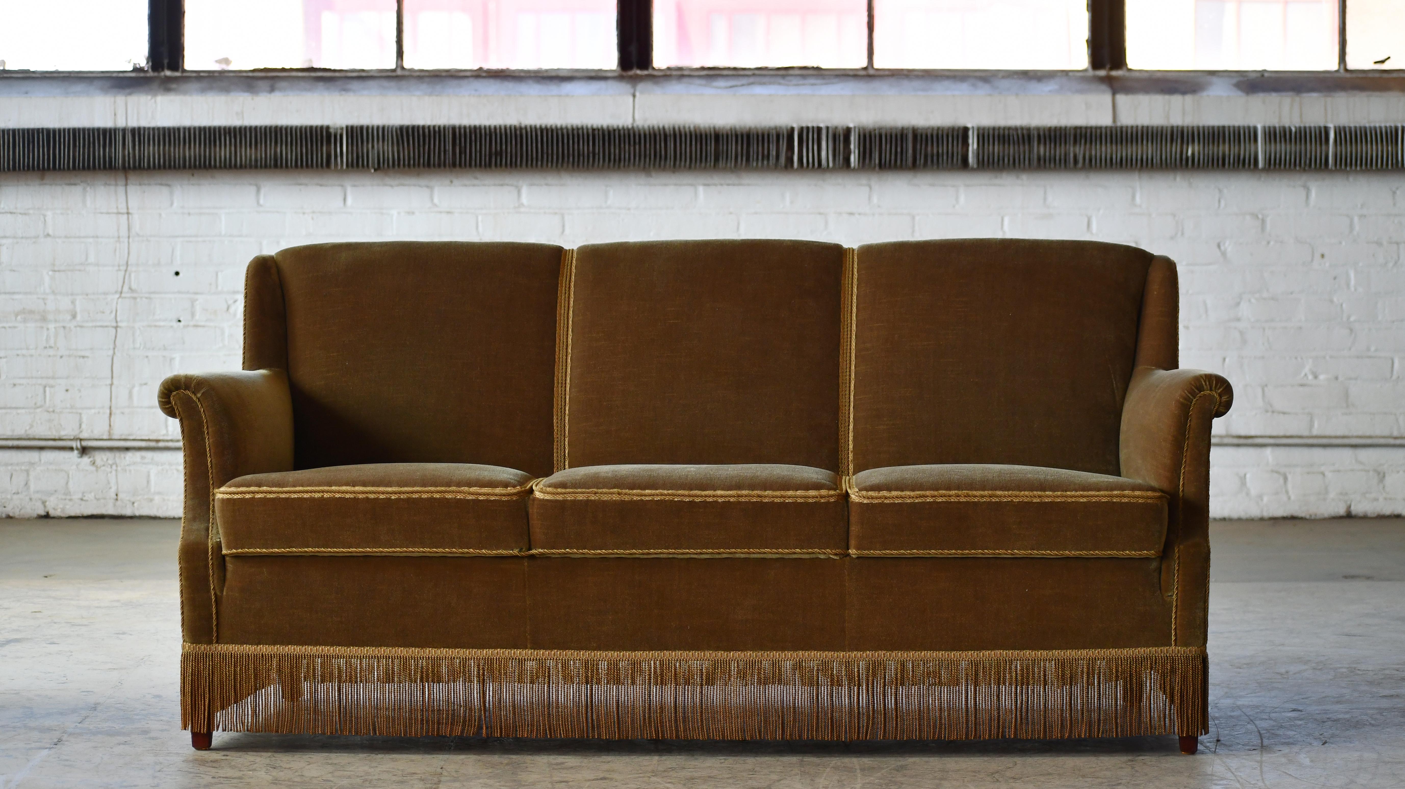 Charming Danish 1950's sofa. Nice classic angular shapes,  plush and elegant. Sturdy and strong and very comfortable with coil springs in the seat and backrest. Great to anchor a smaller living room or a bedroom. The original mohair and padding is