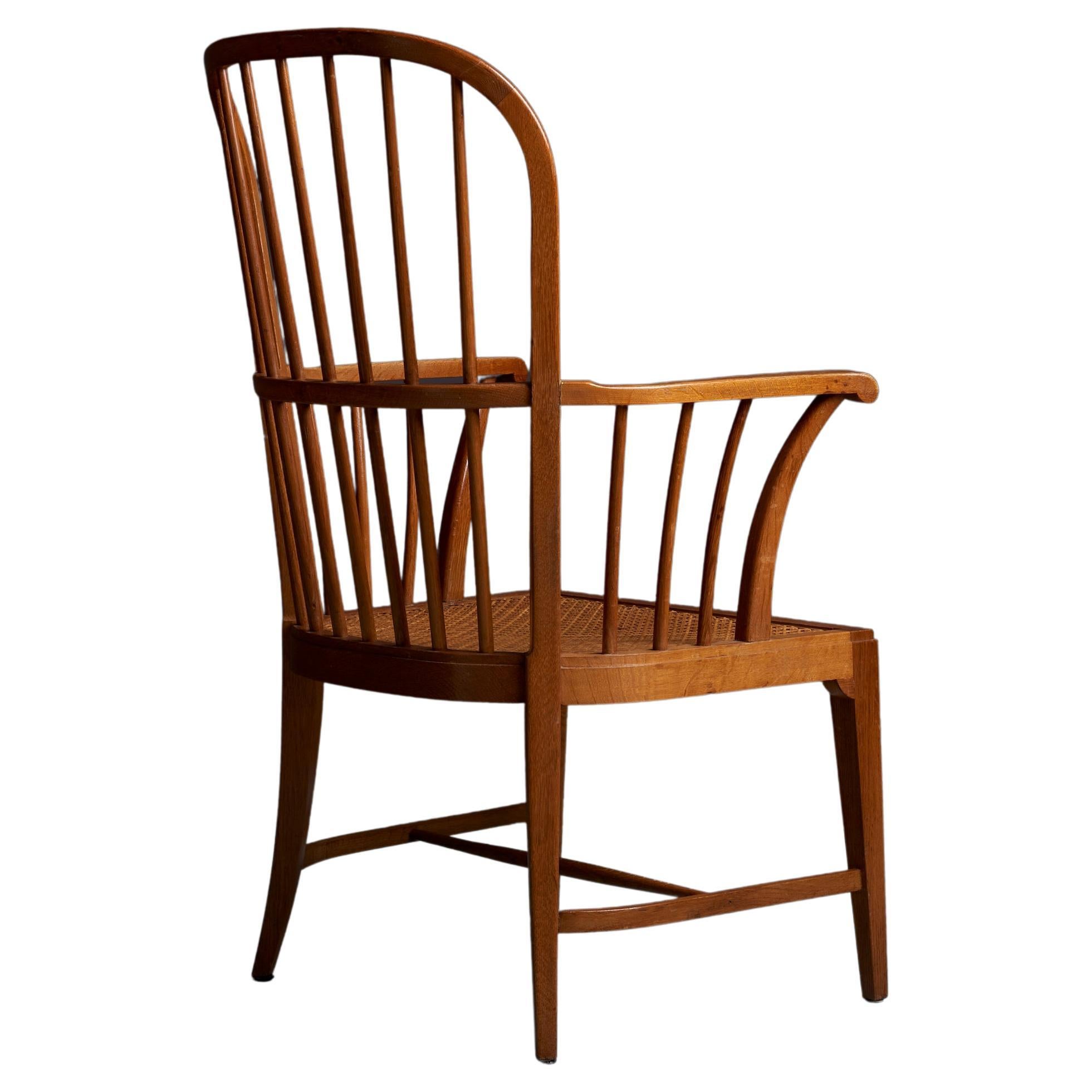 Mid-Century Modern Danish windsor chair in oak in excellent condition. The webbed seat is also perfect.

