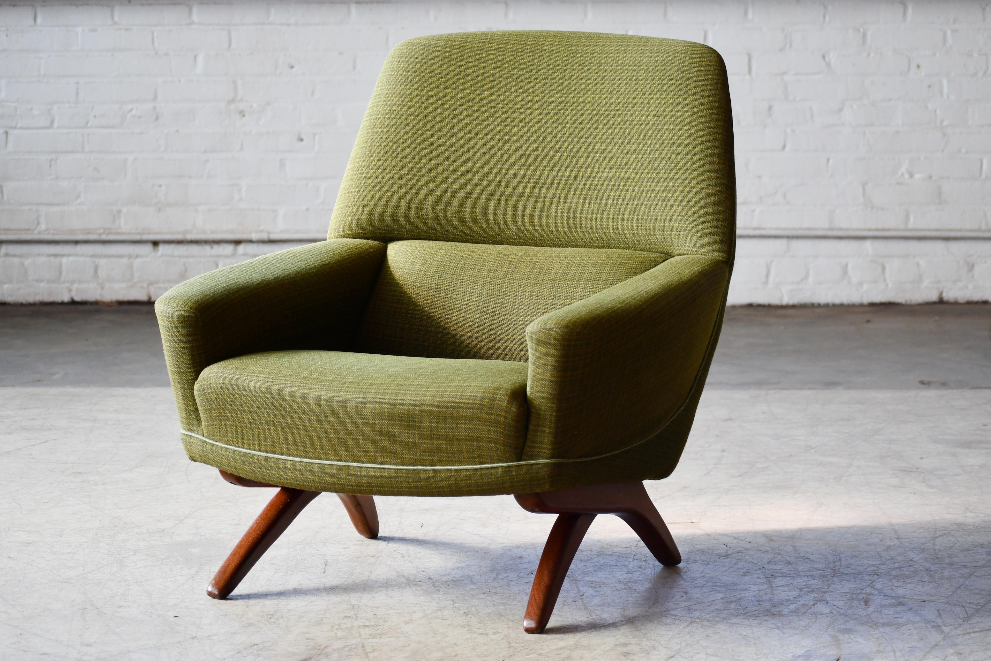 Spectacular design of rounded forms with scissor style base - Classic Illum Wikkelso design made by Aarhus Polstermobelfabrik in the 1960s. Stunning profile and superb comfort. The original wool fabric and foam padding are in good usable original