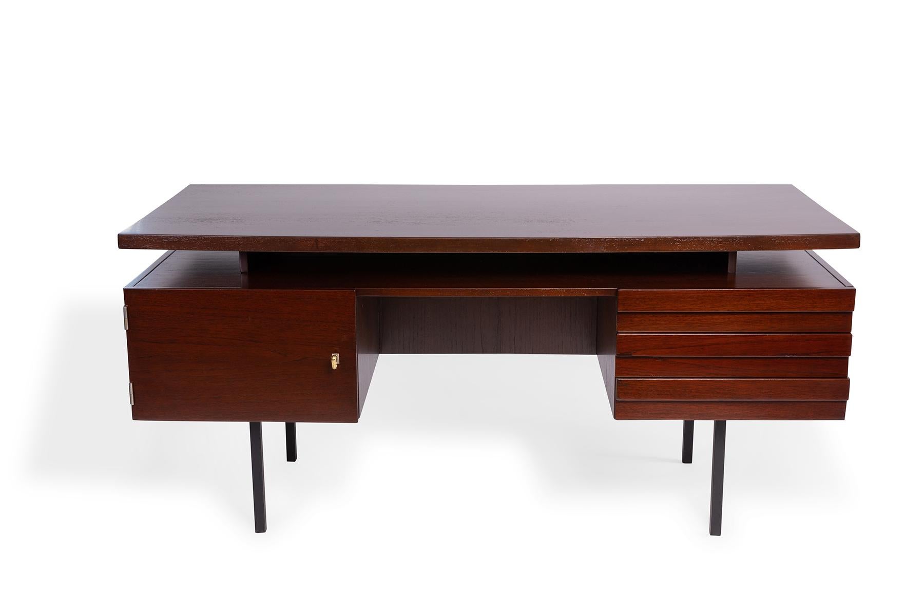 Executive desk from Denmark circa mid-1960s now available. This example has matte black iron legs, open back for additional storage, interior and exterior drawers and original brass key.