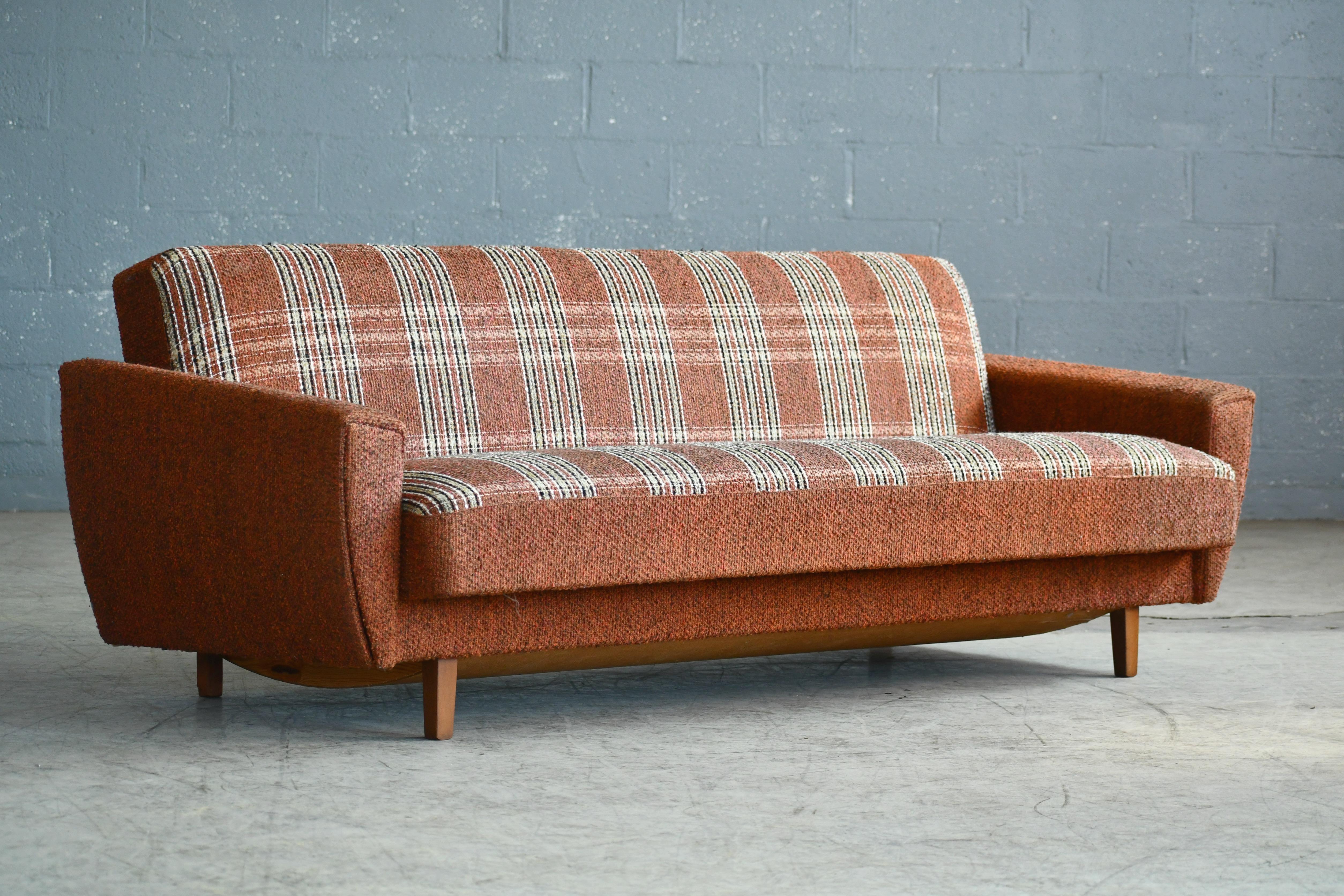 Danish 1960s daybed or sleeper sofa possibly designed by Kurt Østervig for Ryesberg Mobler. Very Classic 1960s design. These chairs bear strong resemblance to Ostervig's characteristic design with tear drop front panels continuing to the backside of
