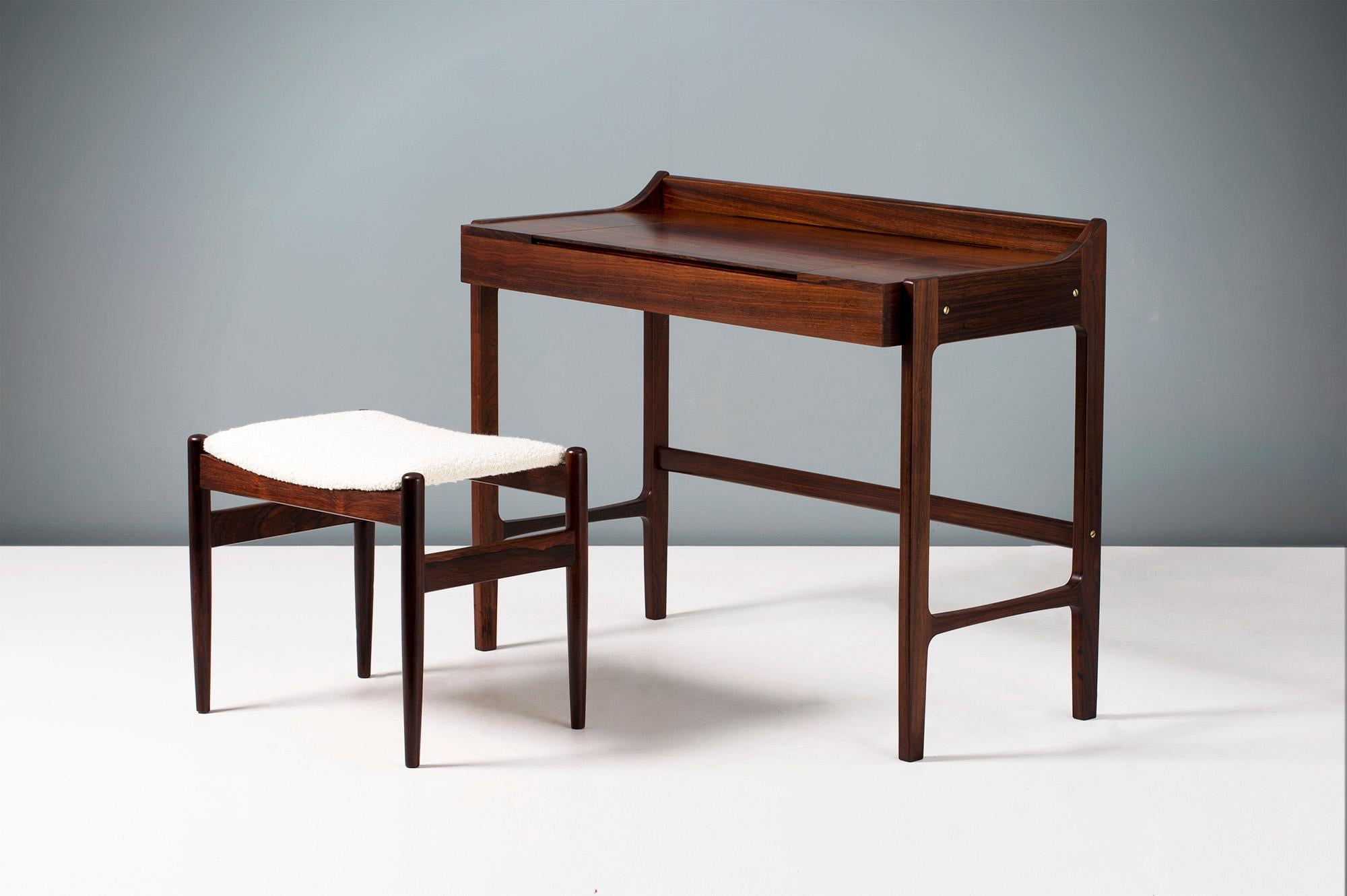 Danish Cabinetmaker

Dressing table, circa 1960

Dressing table made from highly figured exotic rosewood with fold-down mirror on brass fittings. Matching rosewood stool reupholstered in boucle wool fabric.

Measures: H 77cm, D 50cm, W 55cm,