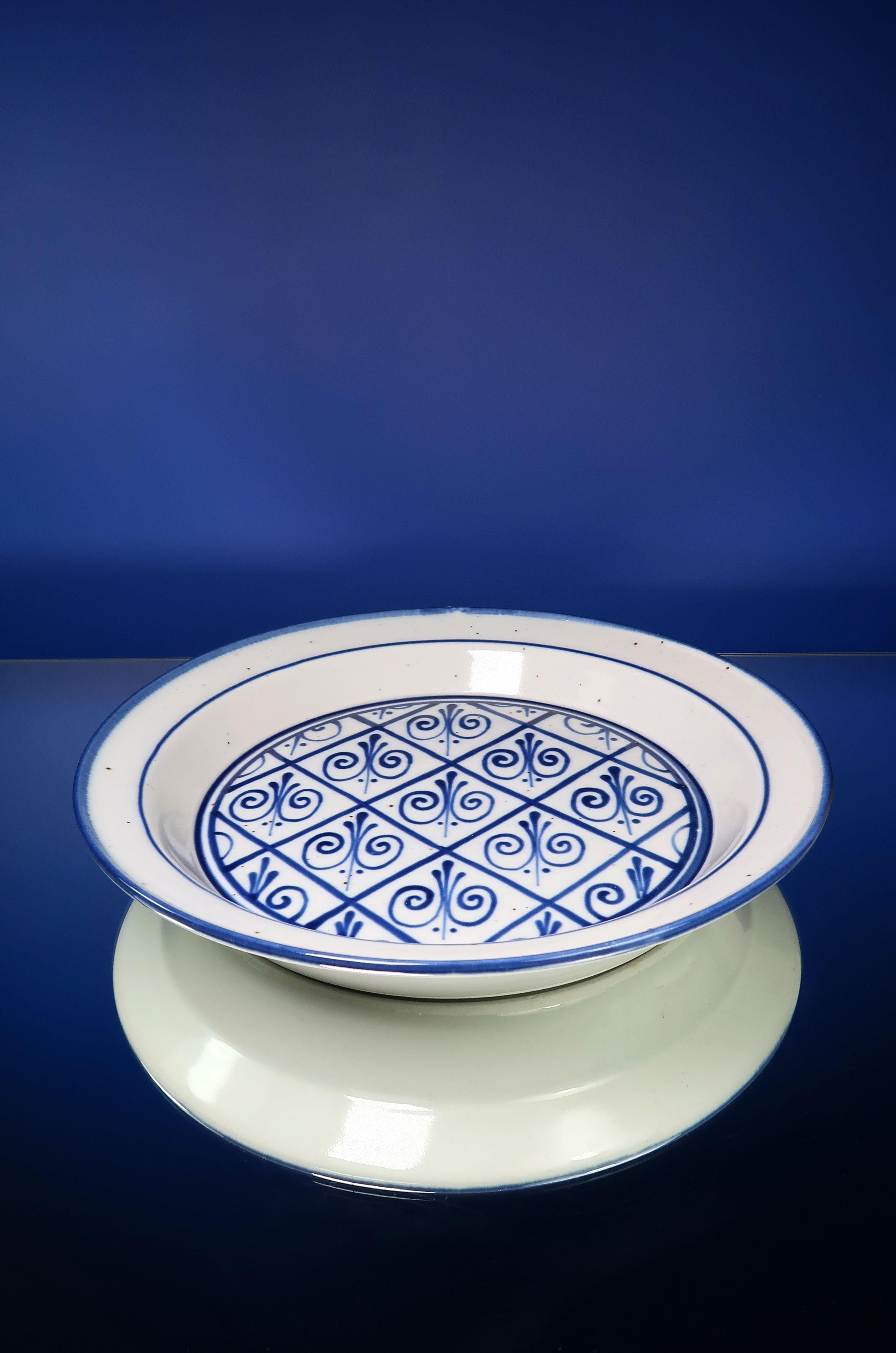 Beautiful Danish midcentury modern stoneware platter, centerpiece or wall decoration with hand painted deep blue floral decorations on light grey base. Designed by Niels Refsgaard for Eslau in 1966. Part of the Generation series manufactured for the