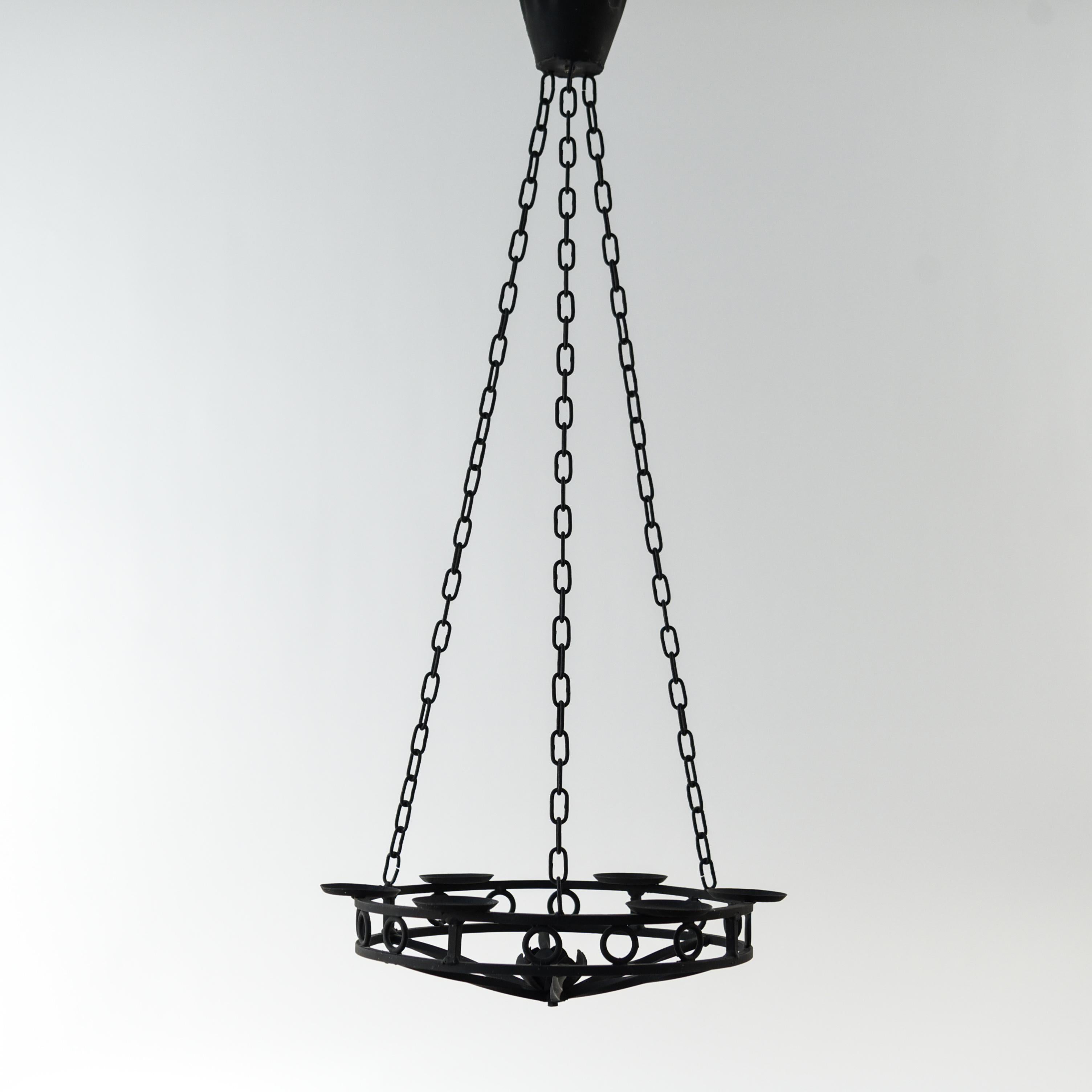 This Danish chandelier is from the 1970s. This piece has six platforms to hold candles and has a beautiful rustic appearance.