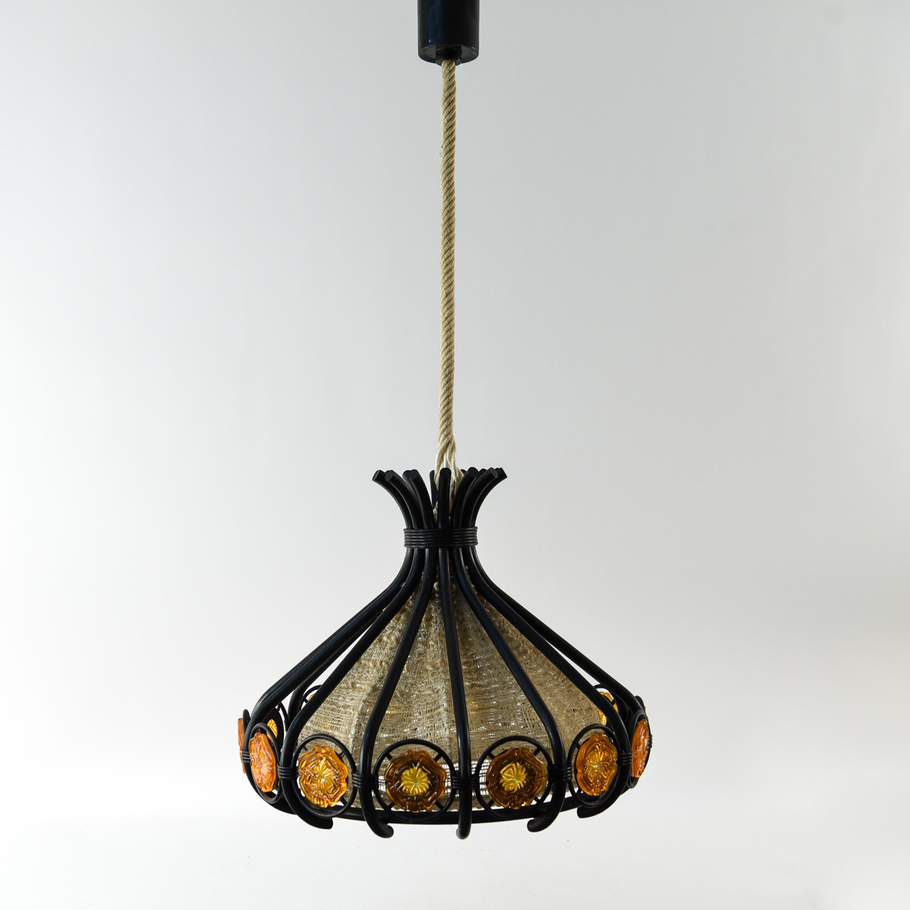 This is a very interesting Danish pendant light from the 1970s. This piece is full of appealing details from the texture of the interior body to the outer framework with orange glass inserts.