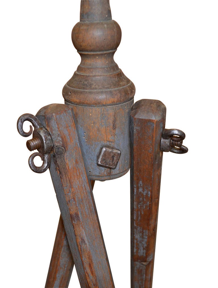 Surveyors tripod level tool from the late 19th century. The tripod is made of wood and the level is brass. The wood tripod is 39.75in high.