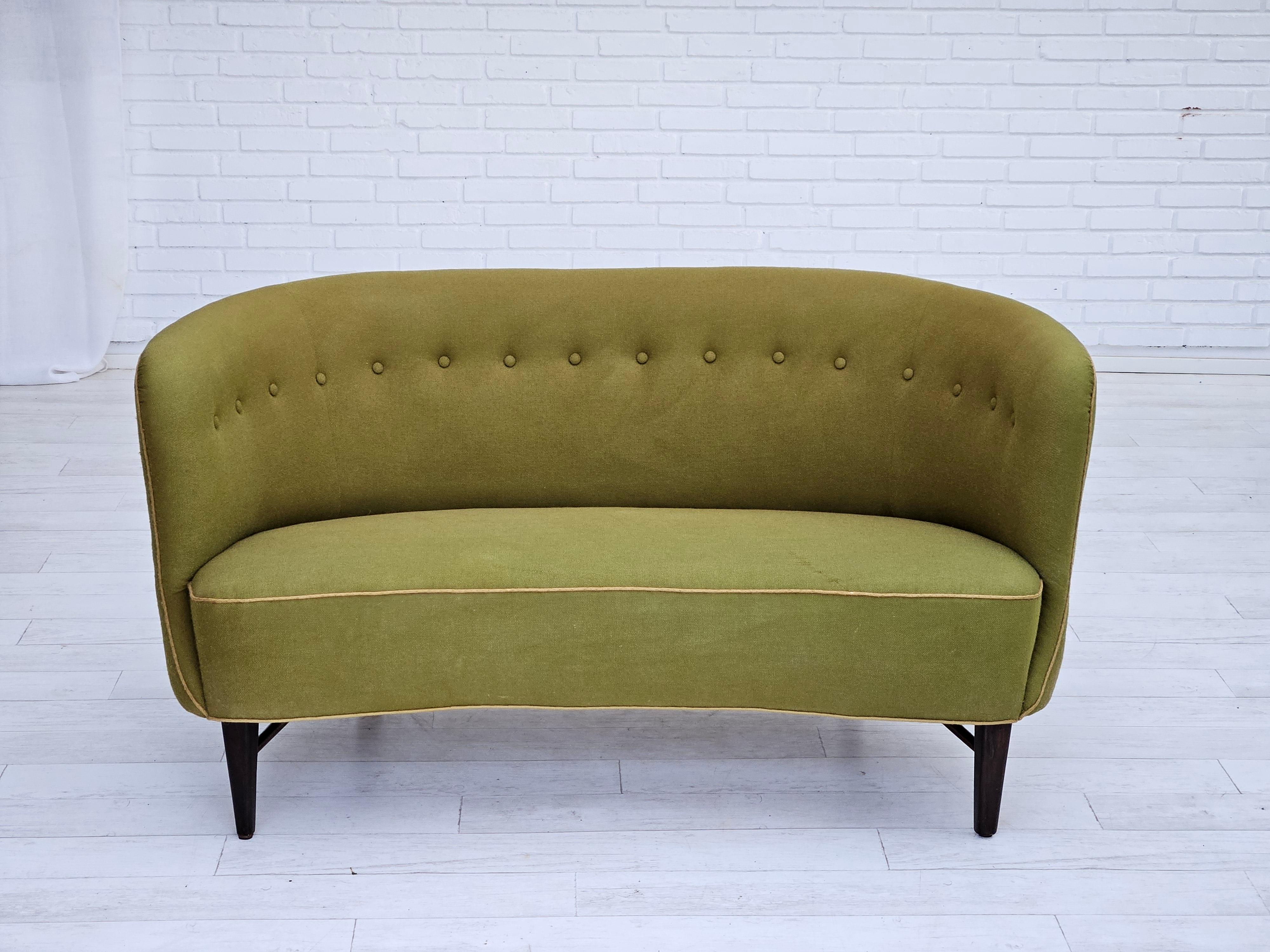 1960s, Danish two seater sofa. Original good condition: no smells and no stains. Furniture olive green wool fabric, dark oak wood legs. Springs in the seat. Manufactured by Danish furniture manufacturer in about 1960s.
