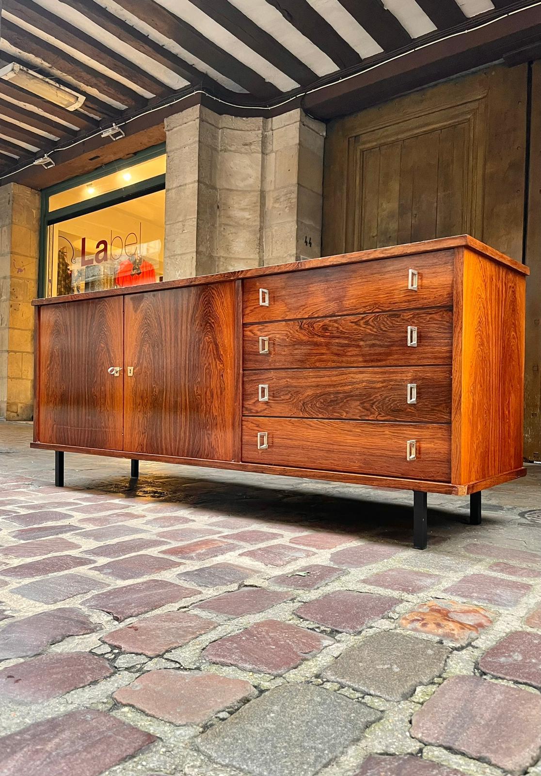 This Danish 20th-century dining table, crafted from exquisite rosewood, exemplifies the timeless elegance of mid-century modern design. The rich, dark tones of the rosewood, with its beautifully intricate grain patterns, bring warmth and