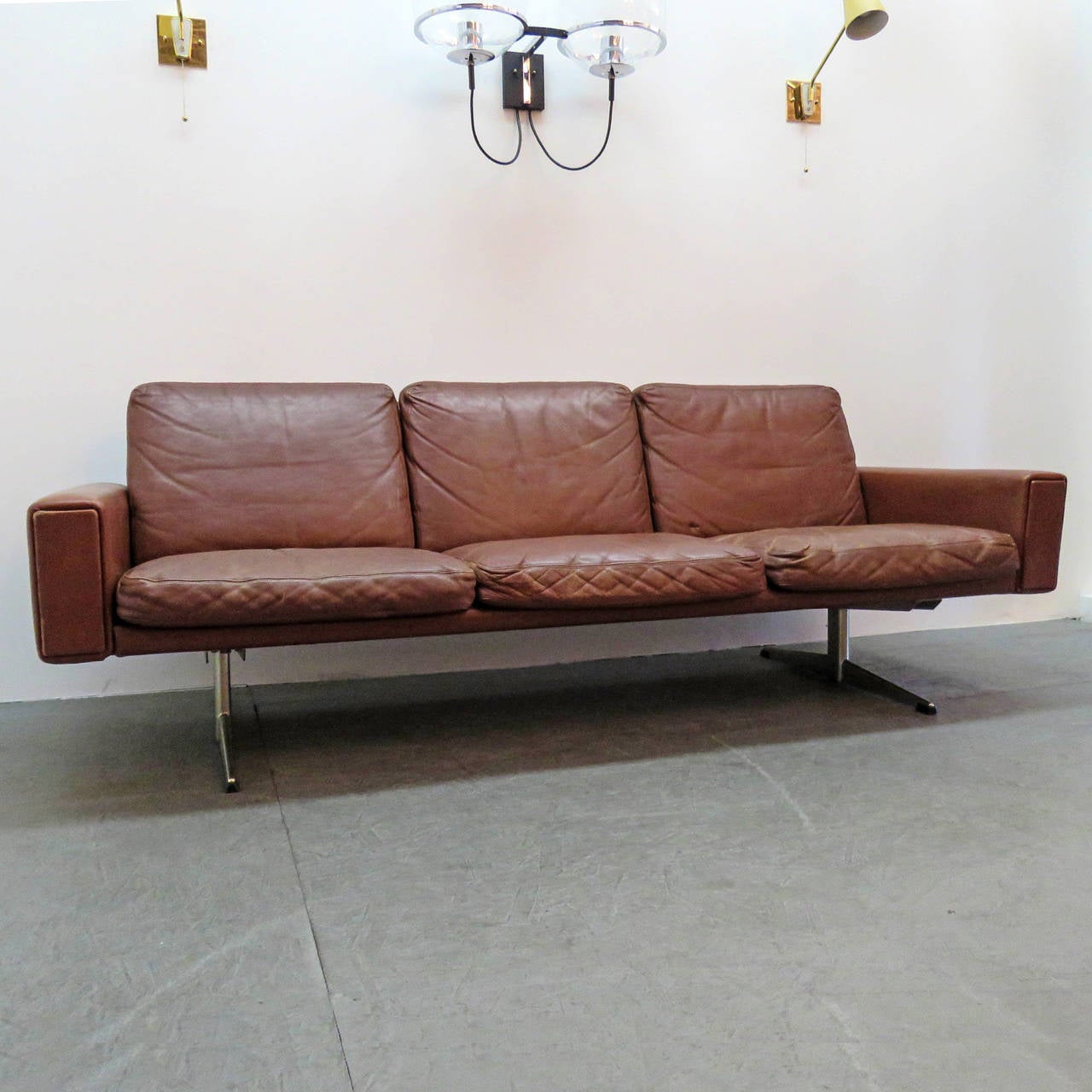Wonderful 1960 Danish brown leather sofa, with chrome-plated metal legs, great shape, low profile, wonderful patina to the leather.