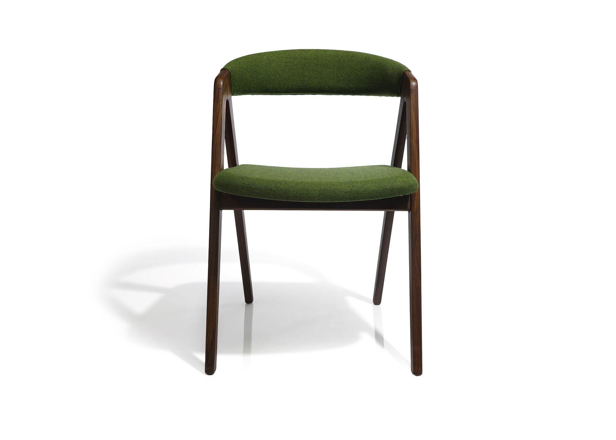Solid walnut curved back dining chairs newly upholstered in an olive green wool fabric. Sturdy, dark walnut frames fully restored in a natural oil. Comfortable curved backrests. Professionally restored and in excellent condition.  Additional chairs