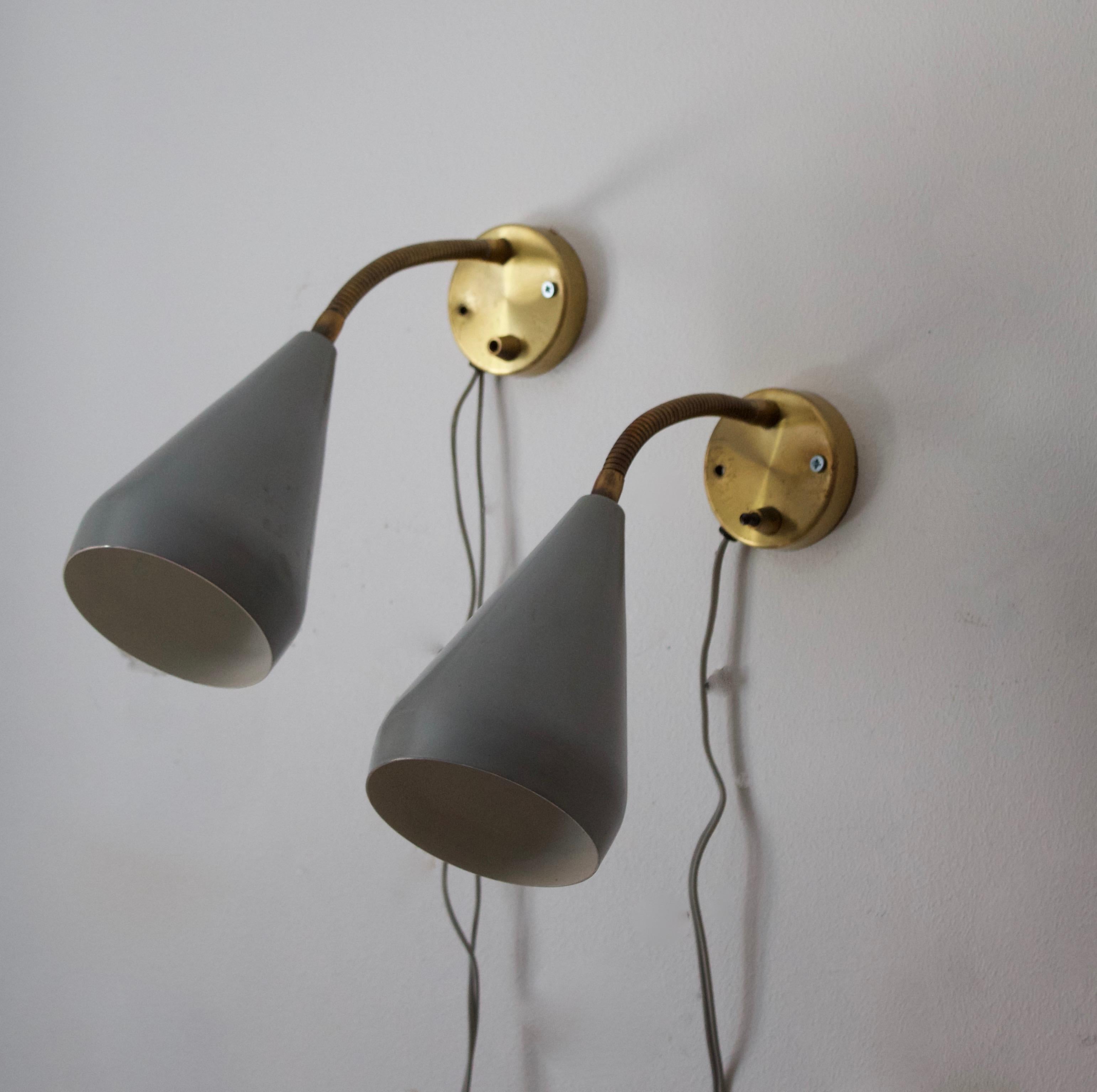 A pair of adjustable wall lights. Designed and produced in Sweden, 1950s. 

Features green lacquered metal and brass.