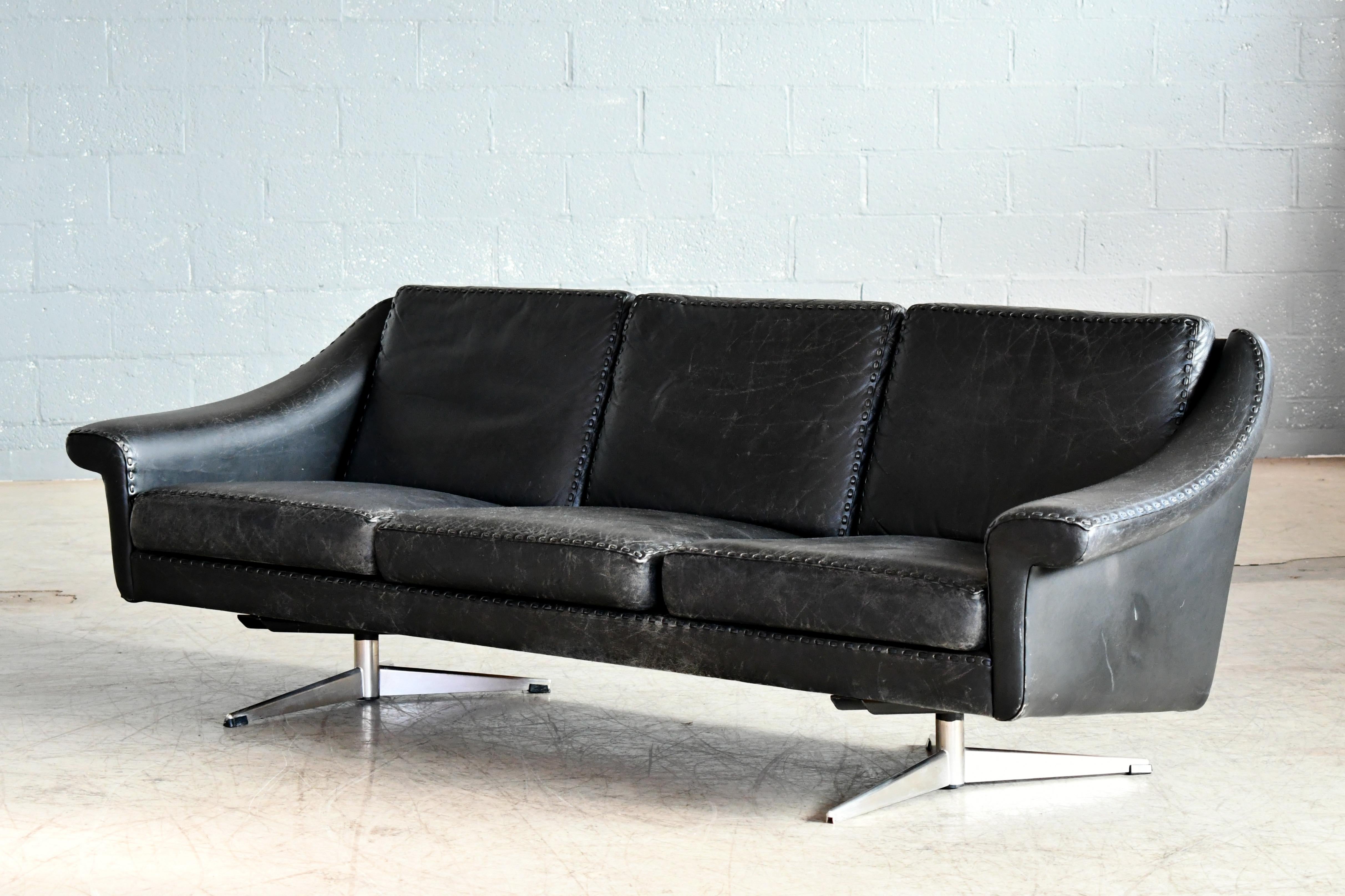 Elegant three seat leather sofa model Matador from 1966 designed by Aage Christiansen in the mid-1960s and produced by Erhardsen & Andersen, Denmark. Upholstered in supple black ox hide leather on a steel l base. Super elegant highest quality with