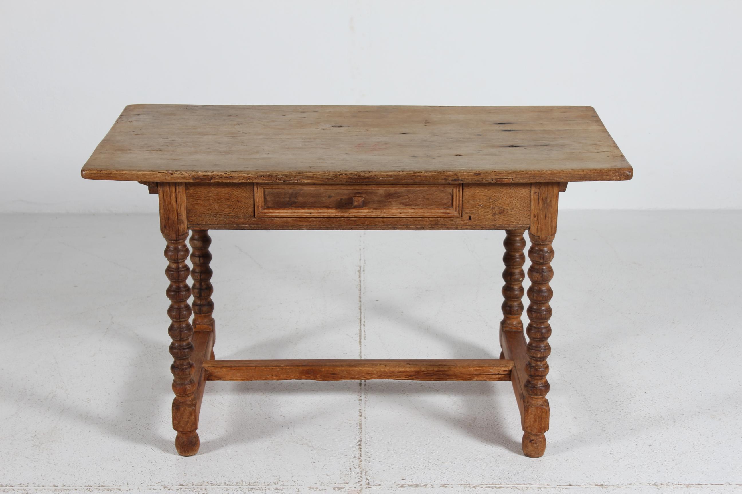 Danish high baroque style coffee table of solid oak with drawer.
Handcrafted by a Danish cabinetmaker in the 1850s, with hand-turned bobbing legs and connecting bar between the two set of legs.

The past many years have added a beautiful patina, the