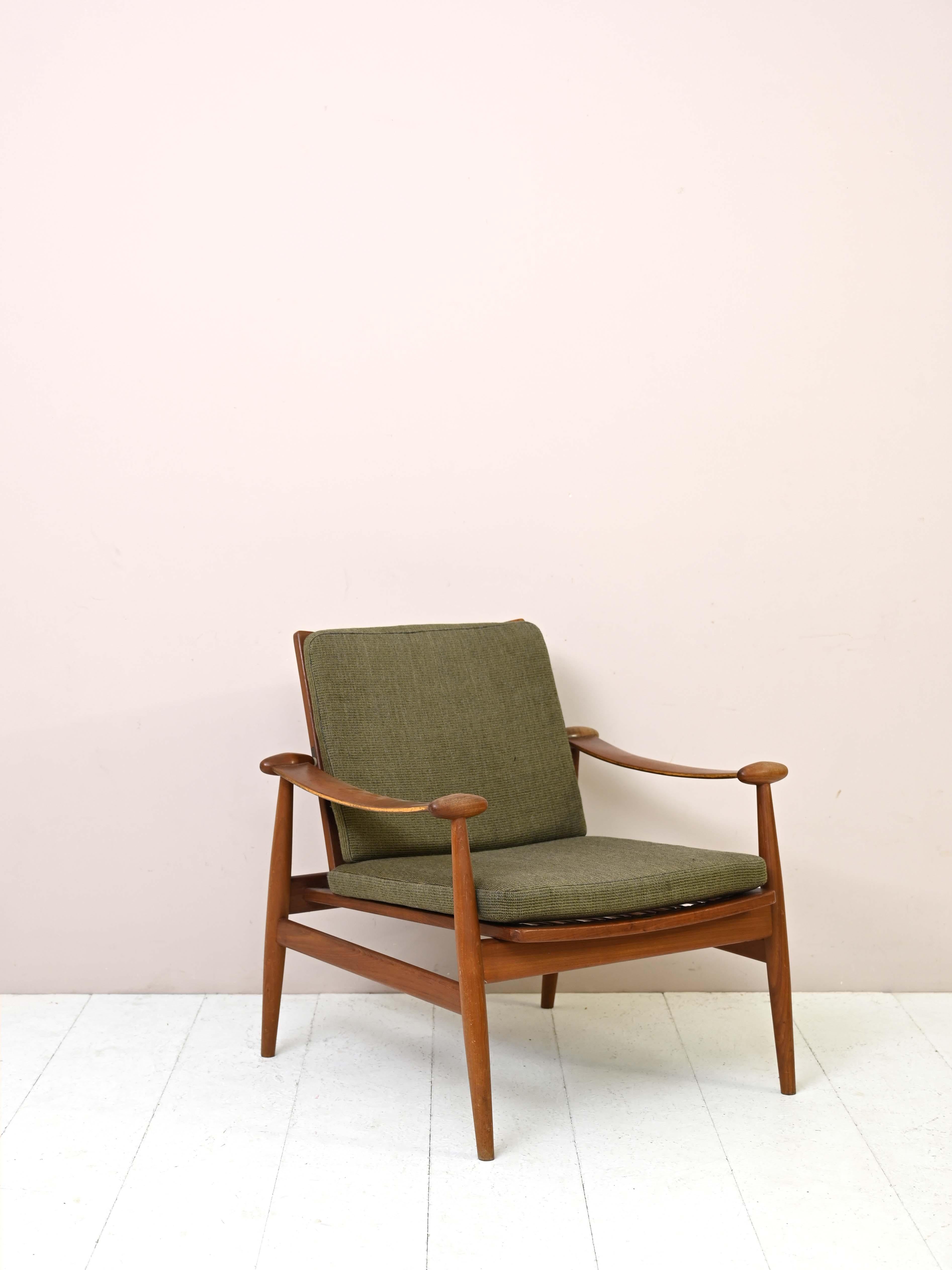 Armchair model FD 133 original vintage.

This uniquely designed and elegant armchair was designed by Finn Juhl in the 1960s.
The frame is solid teak wood and the upholstered cushions have the original vintage fabric.
The distinguishing feature