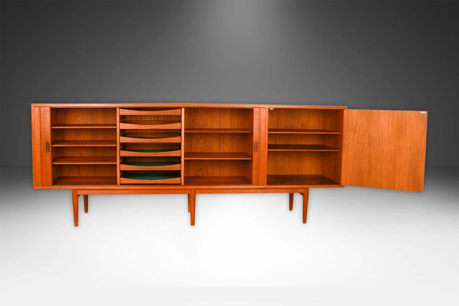 Exceptional Mid-Century teak, rare, sliding tambour door, credenza designed by Arne Vodder for Sibast Mobler made in Denmark, circa 1960’s. World famous for winning the Gold Medal at the 1958 Milan Triennale design awards. This smartly crafted