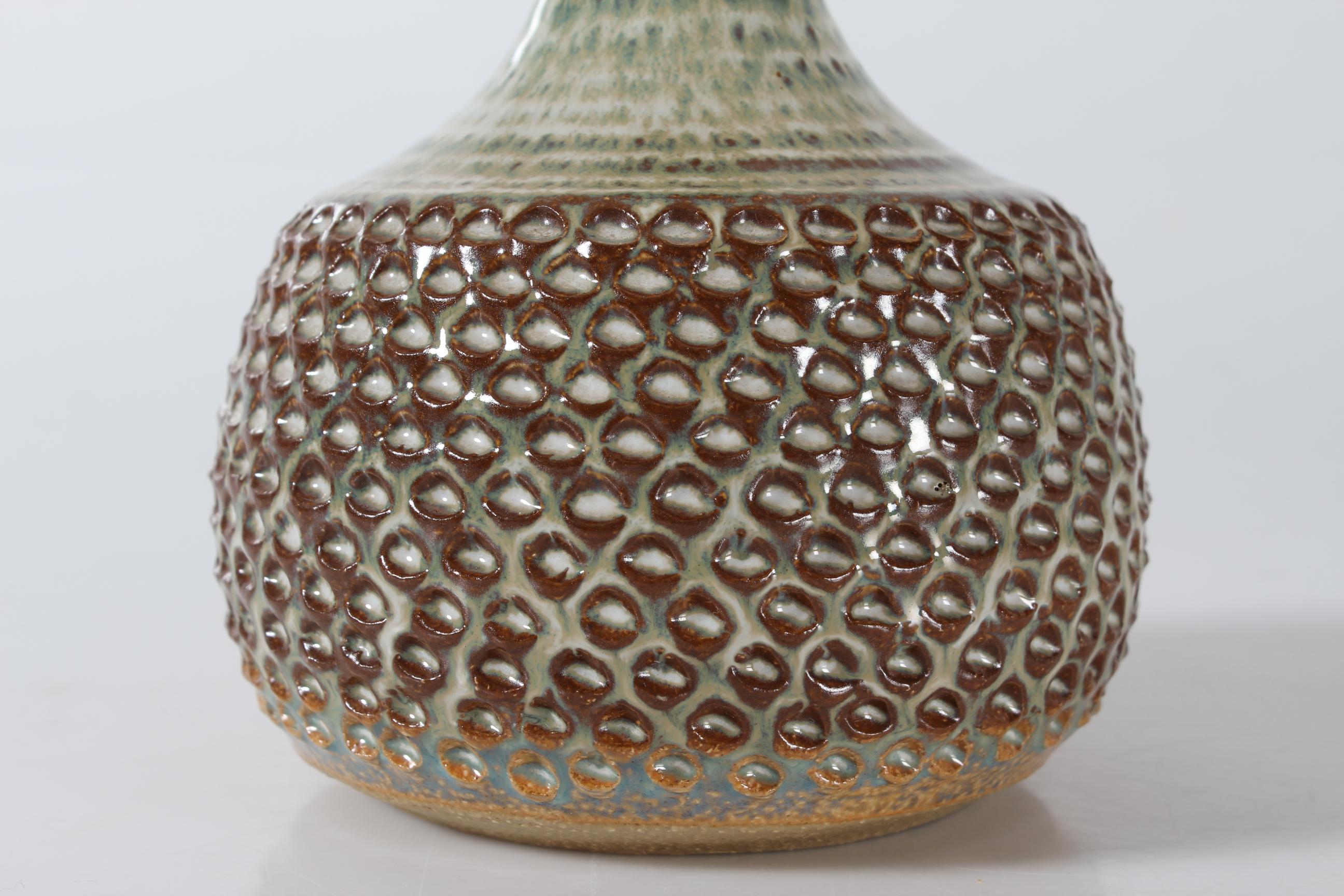 Small stoneware table lamp by  Søholm Stentøj, Denmark, circa 1960s.
The lamp has yellowish green, brown and white glaze with speckles over an fish scale pattern.

Included is a new clip on lamp shade designed and made in Denmark. It is made of