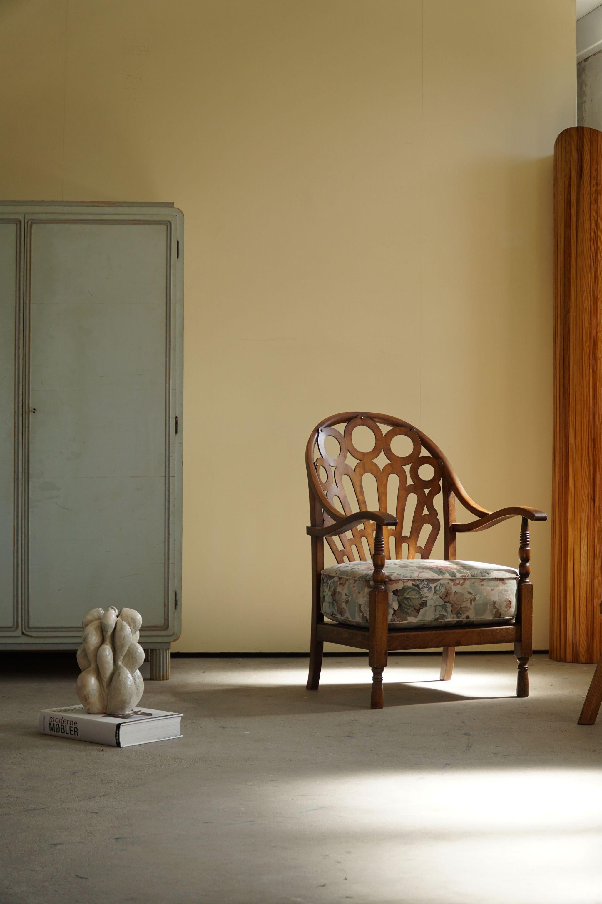 Decorative art deco lounge chair in beech, seat with flower motives. Made by a Danish Cabinetmaker in the early 20th century. Beautiful carved back with many details.

The overall impression of this vintage chair is great.

