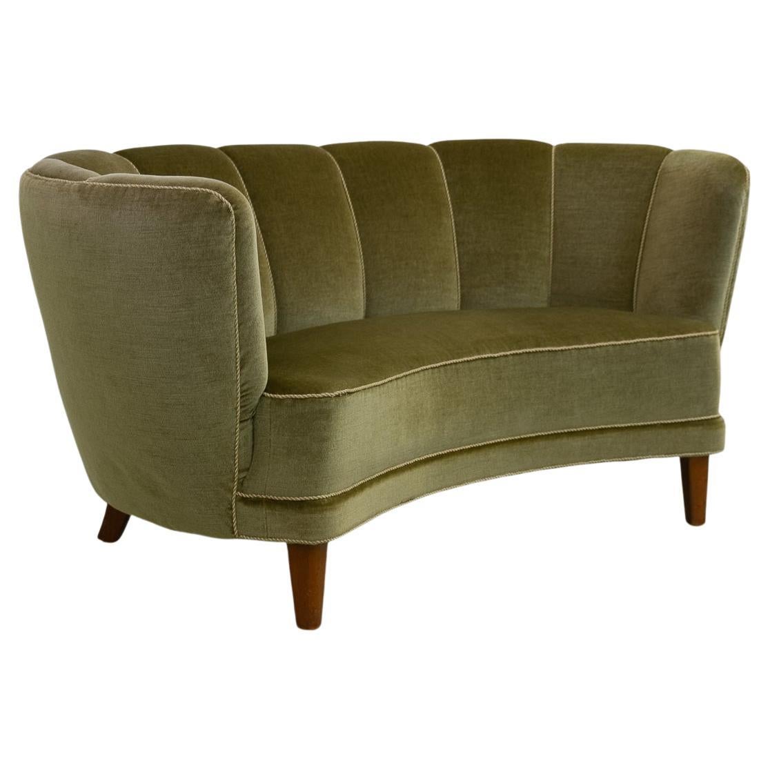 Danish Art Deco Banana Sofa in Green Velvet, 1940s.

Vintage Art Deco banana-shaped loveseat upholstered in green mohair velvet made by cabinetmaker in Denmark in the 1940s. Curved two-seater with original spring and velour upholstery. Feet in