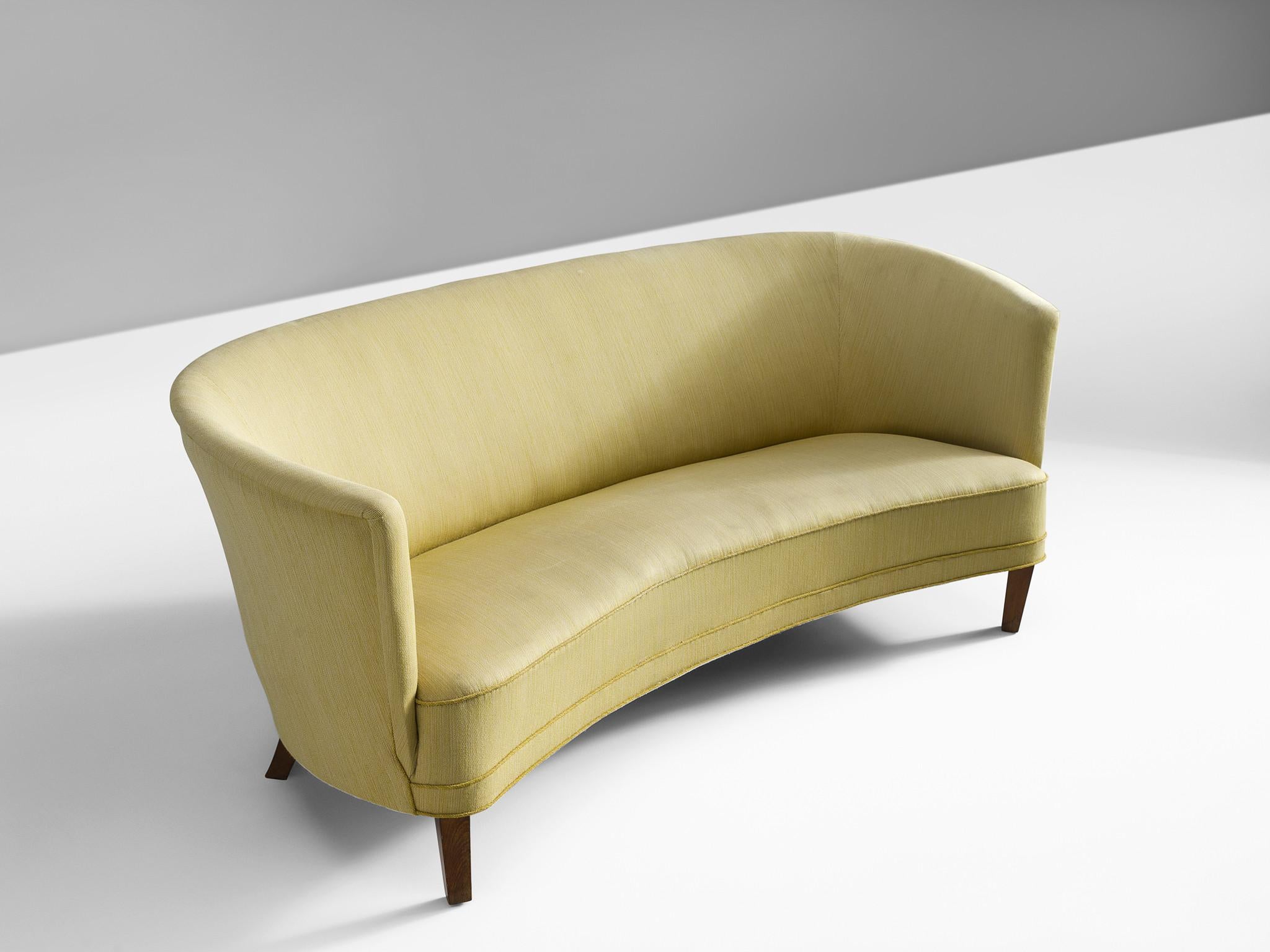 Sofa, fabric and wood, Denmark, 1950s.

Simplistic Danish sofa with clean lines and a high back. The sofa features small tapered wooden legs. The seat is thick and comfortable and is finished with piping. The high back embraces the sitter in