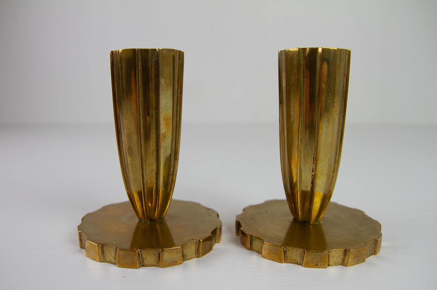 Danish Art Deco Brass Candleholders by Vendor Copenhagen, 1930s. Set of 2.
Lovely pair of heavy solid brass candlesticks by Danish manufacturer Vendor Copenhagen, Denmark. 
Tapered fluted body on wide round base, in the style of Tinos.

Marked