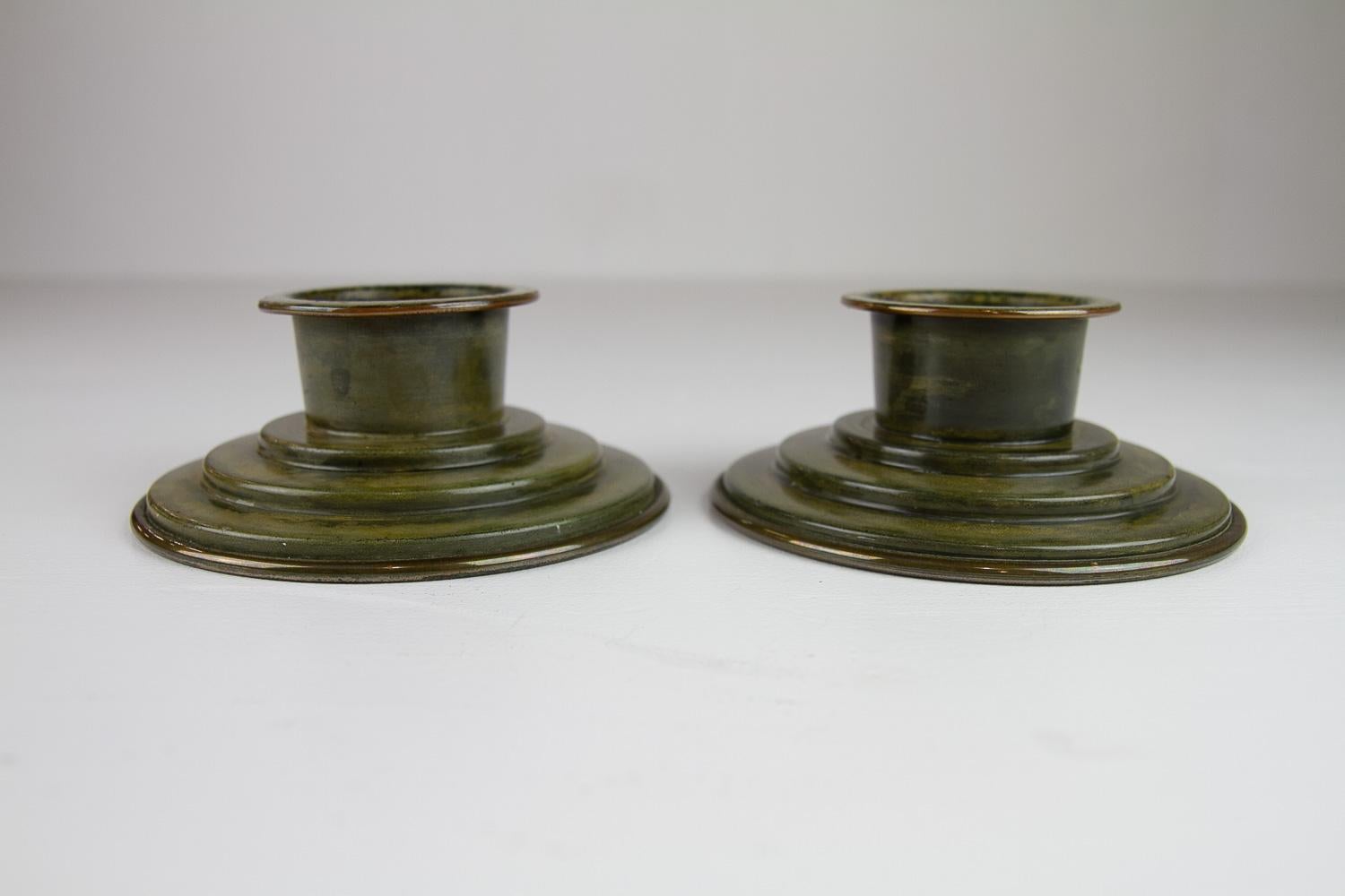 Danish Art Deco Bronze Candleholders by HF Bronce, 1930s.

Pair of patinated bronze candle holders made by Danish manufacturer HF Bronce, Denmark in the 1930s.
Made from thin bronze plate.
Candle diameter: 45 millimeters.

Patina consistent with age