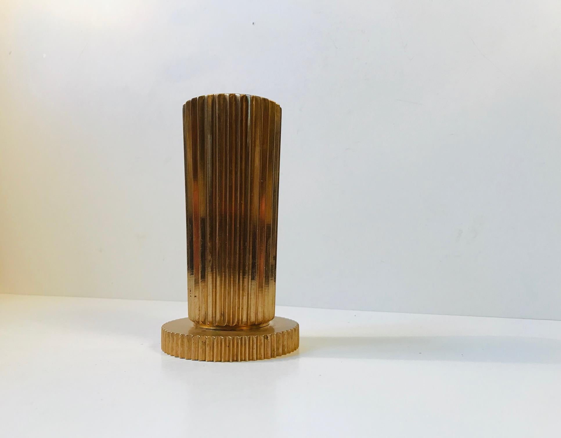 Fluted cylindrical bronze vase with a circular base. It was designed and manufactured by Tinos in Denmark during the 1930s.